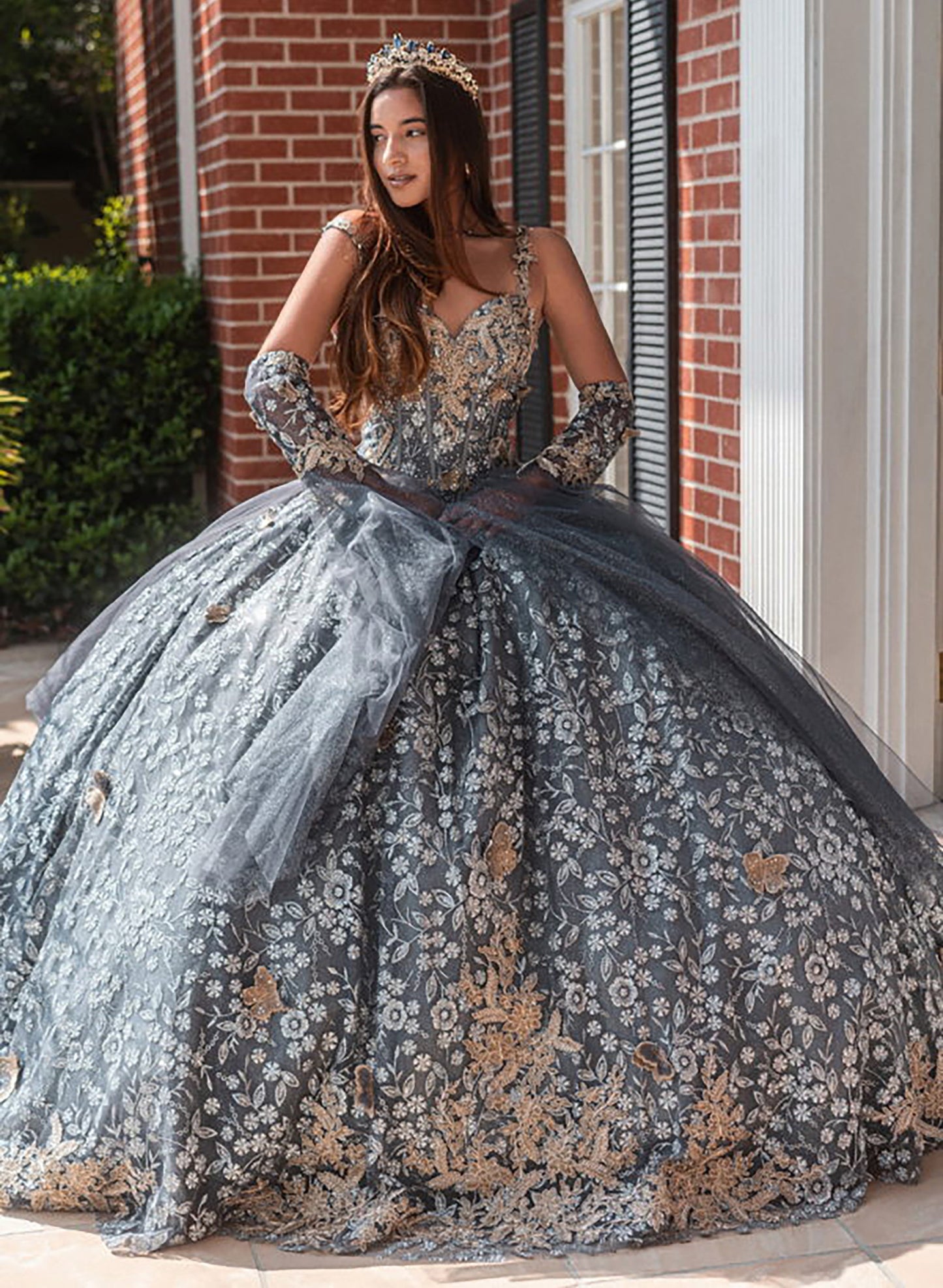 Quinceañera | Gray Black Metallic 3D Butterfly Big Ribbon Mesh Ball Gown with Waist Drape | Rafaela dress front view giril wearing tiara