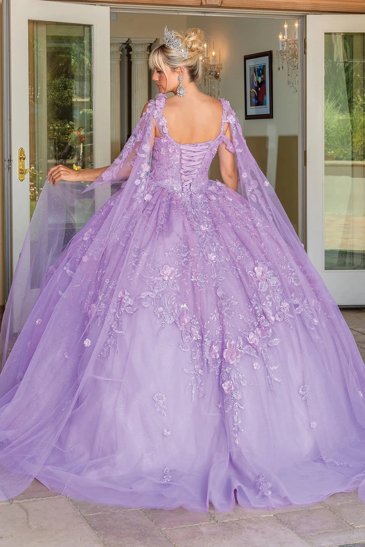 Back view of a Lilac quinceañera gown showing lace-up back, cap sleeves, and layered tulle skirt