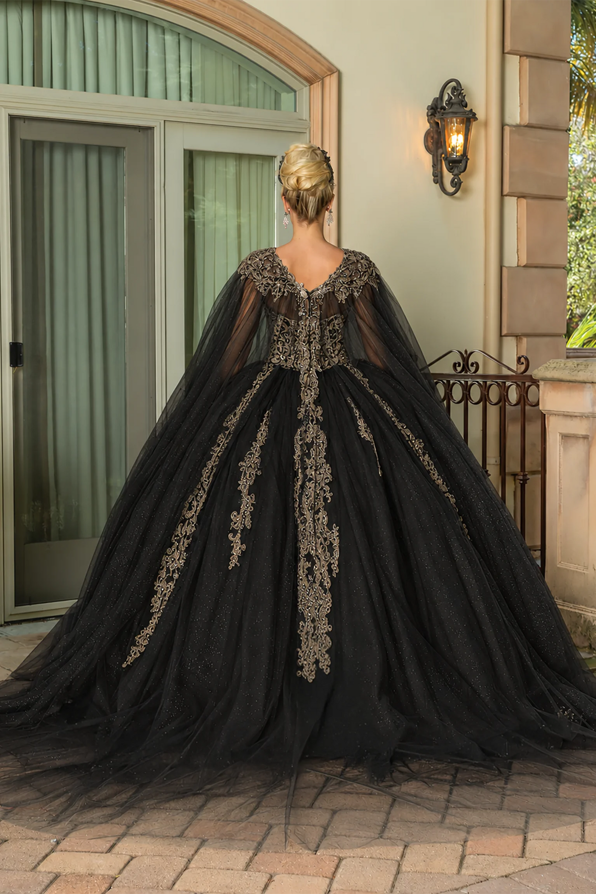 Black embroidered cape quinceanera dress, back view with lace-up closure