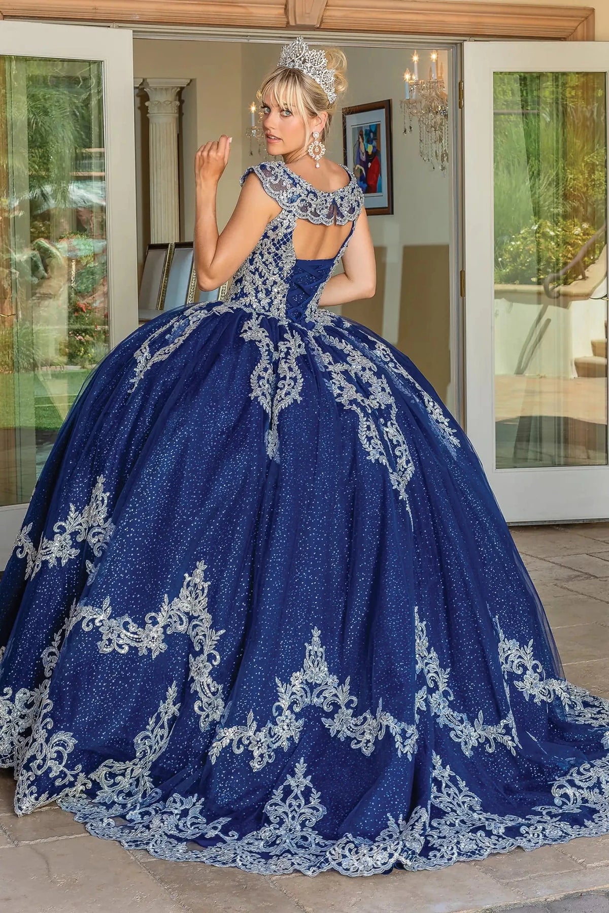 Back view of a Navy quinceañera gown showing lace-up back and cap sleeves