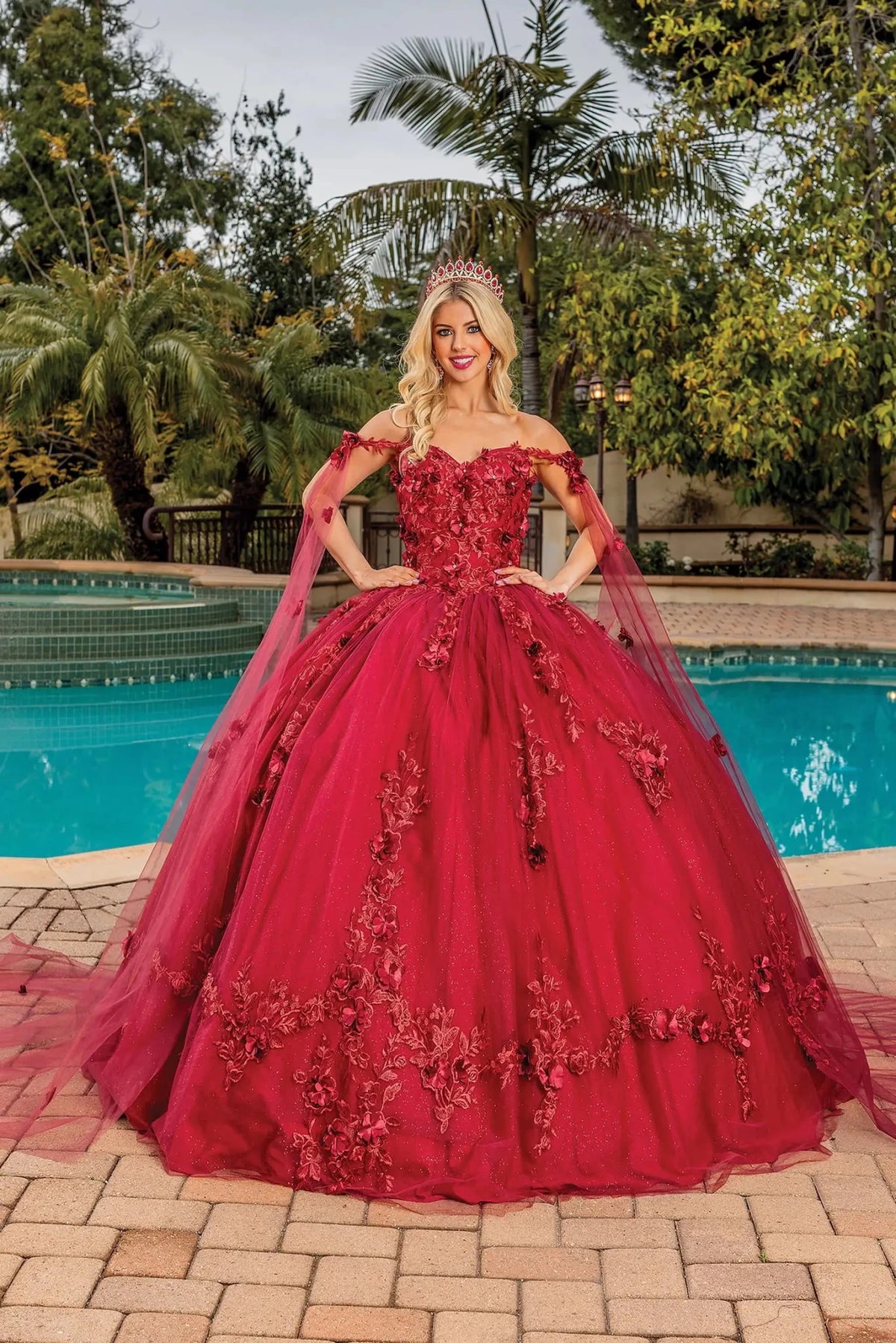 Front view of a Burgundy quinceañera gown with cap sleeves and floral appliqués