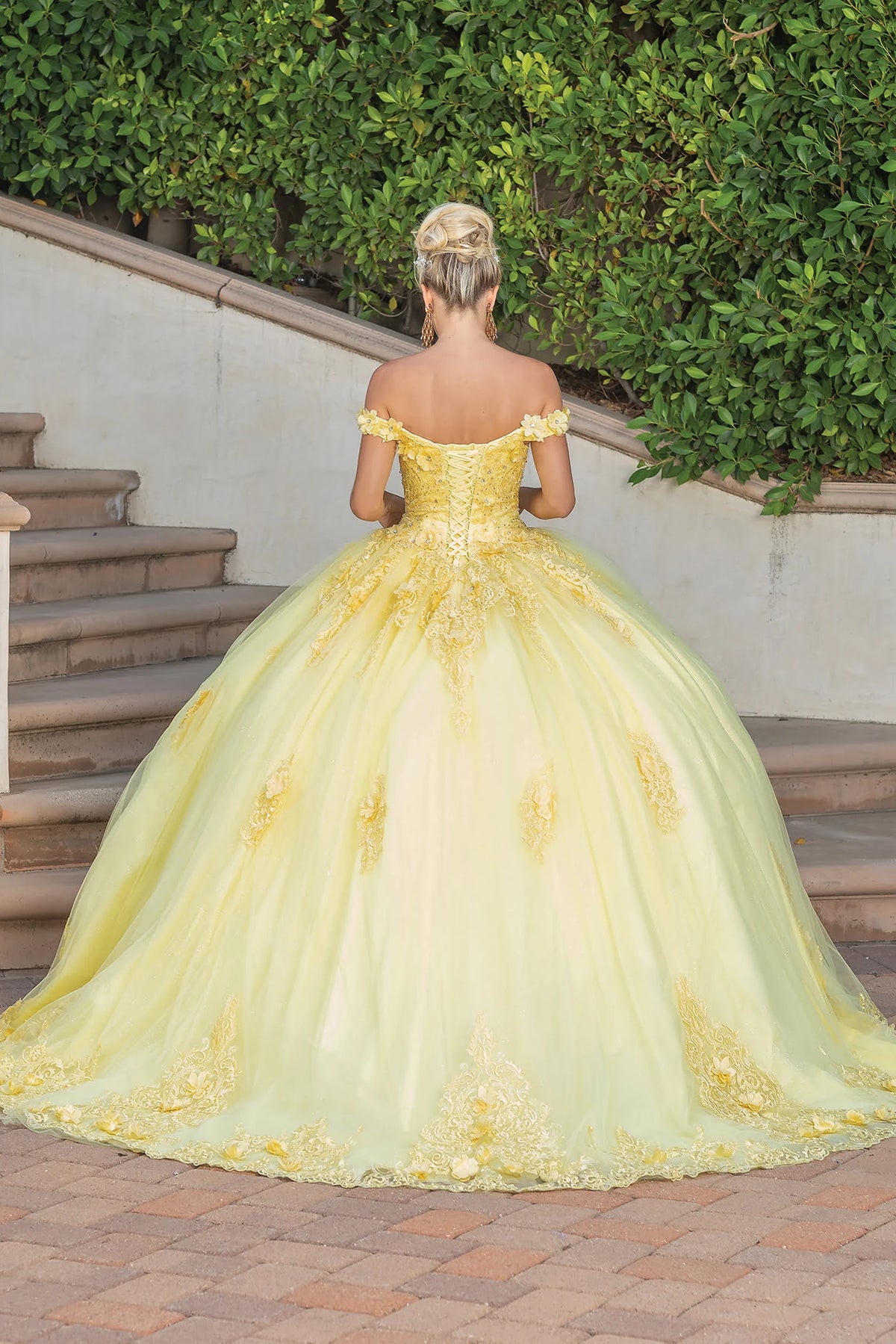From the back, the Yellow quinceañera ball gown reveals its floor-length skirt.