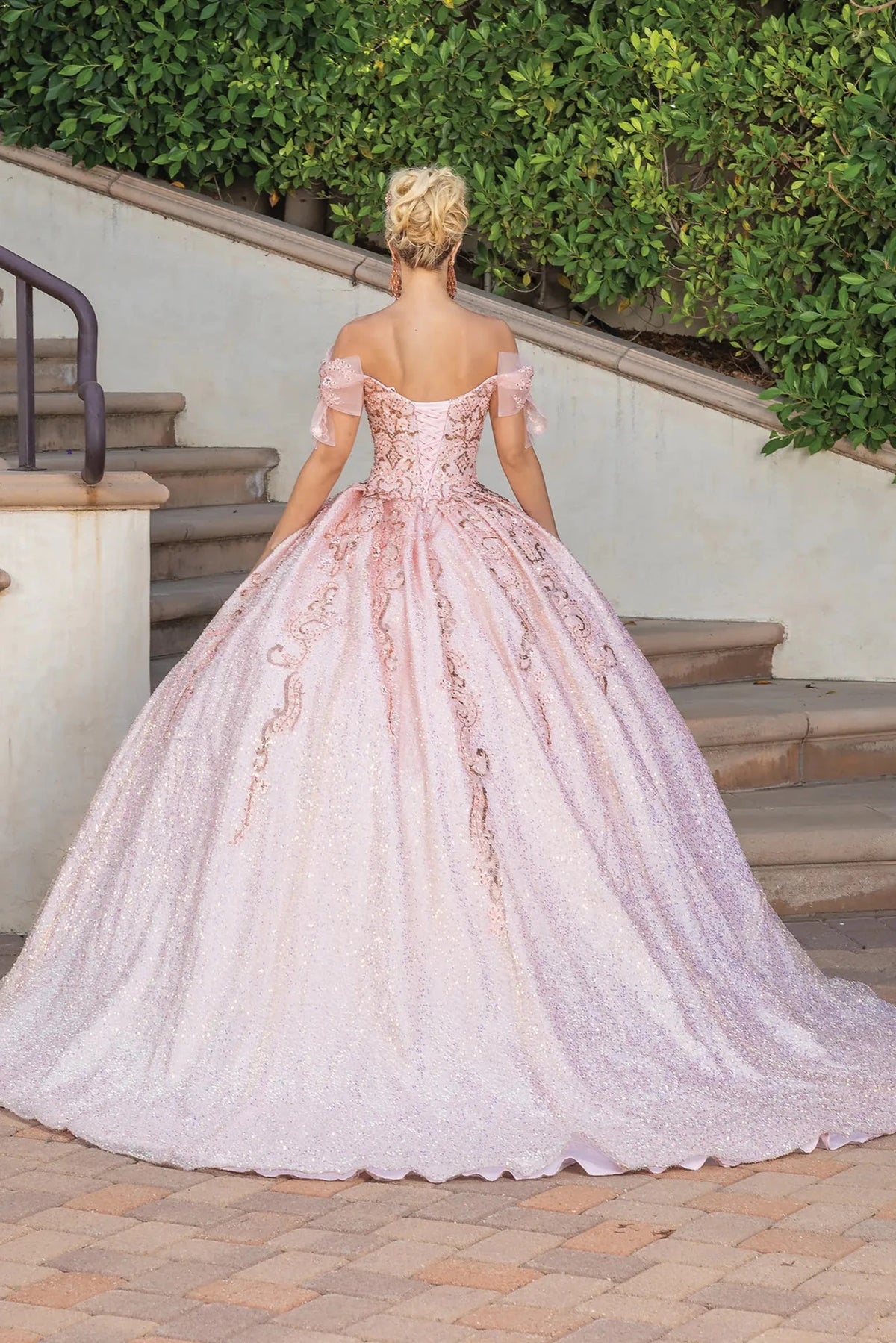 Back view of a Rose Gold quinceañera gown showing lace-up back and cap sleeves
