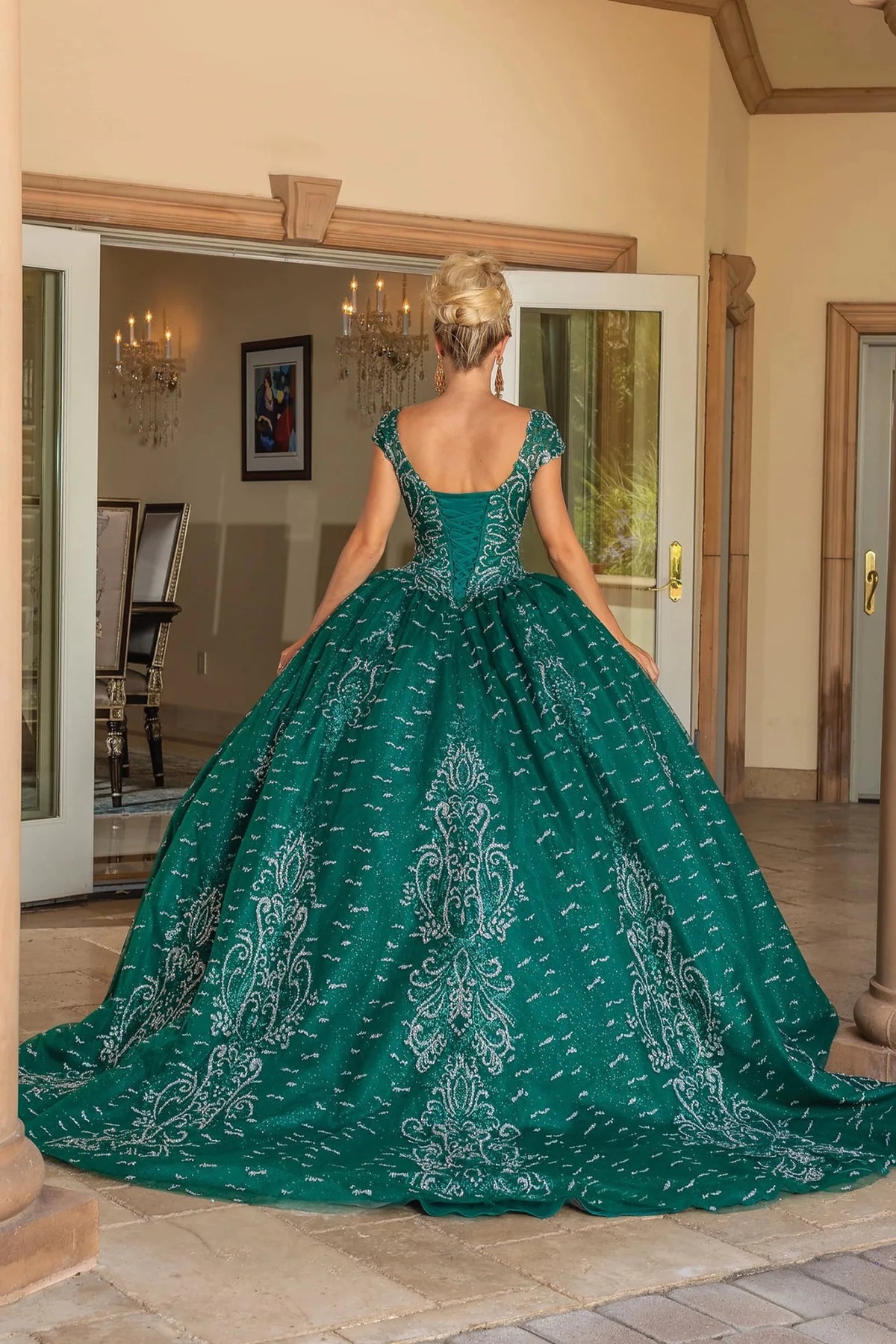 Rear view of a Hunter Green quinceañera gown showing lace-up back and flowing train