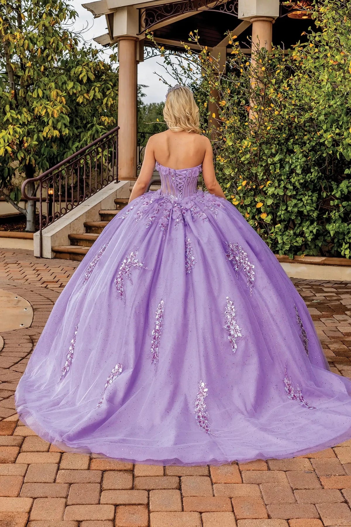 Back portrait of a Lilac quinceañera gown showing lace-up back and floral appliqués