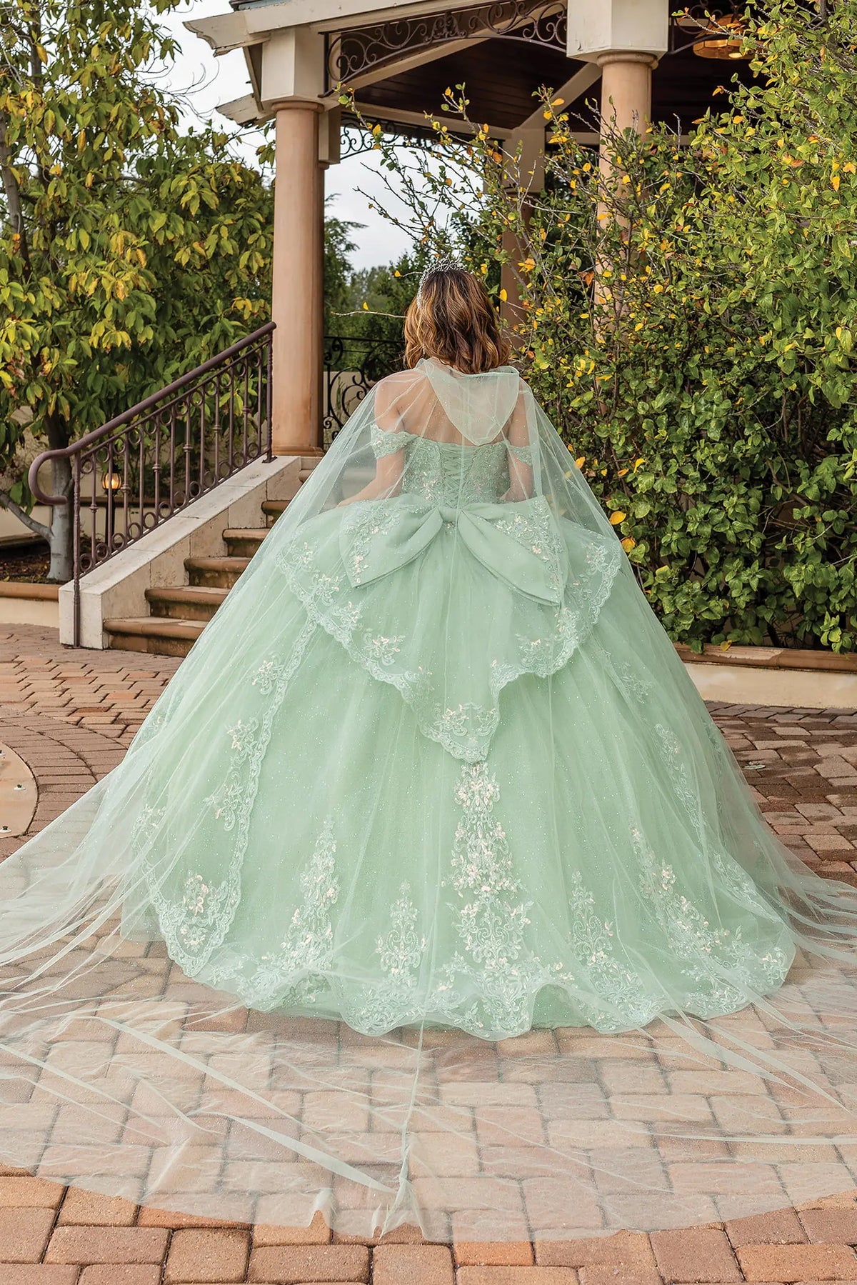 Back view of a Sage quinceañera gown showing lace-up back, detachable sleeves, and embroidered tulle skirt