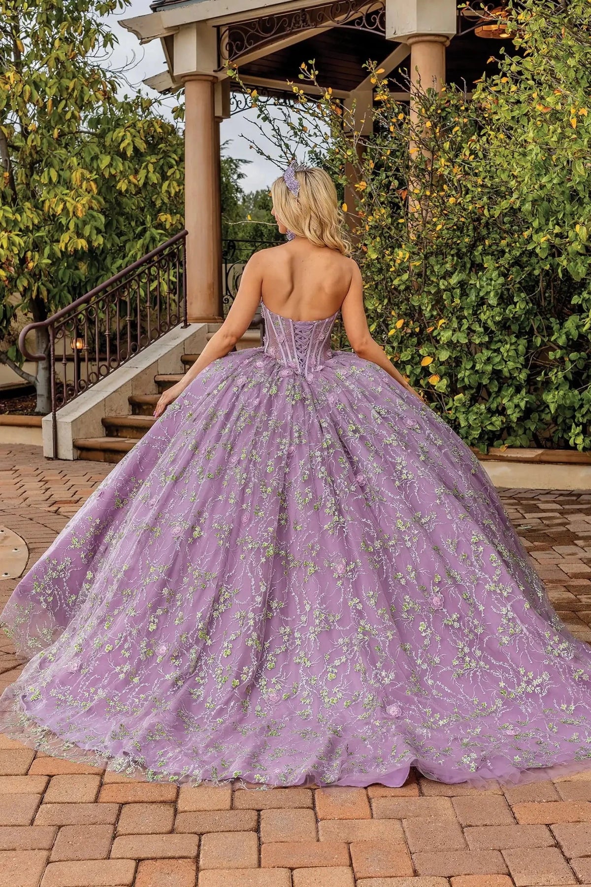 Back view of a Dusty Lilac quinceañera gown showing lace-up back, full tulle skirt, and embroidered lace