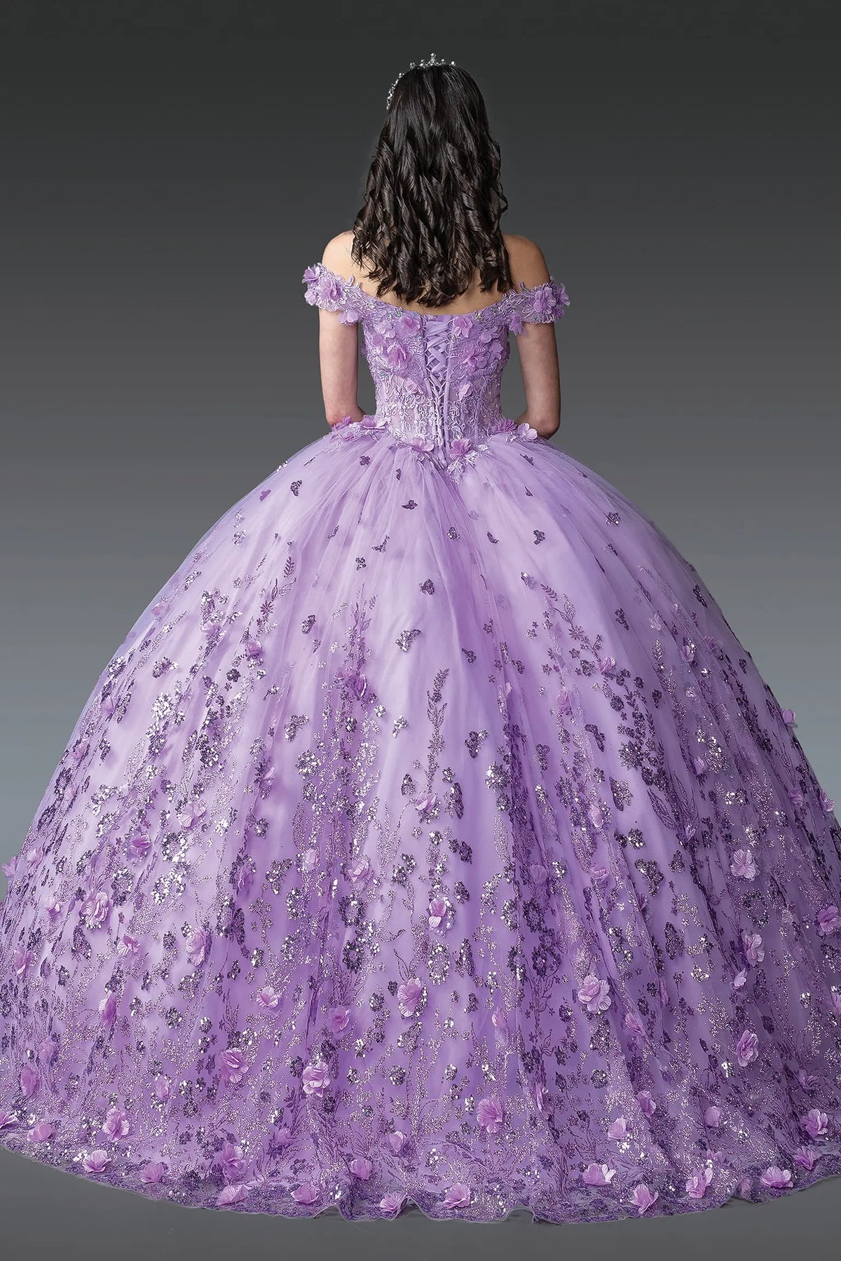 Back view of a Lilac quinceañera gown showing lace-up back and floral appliqués