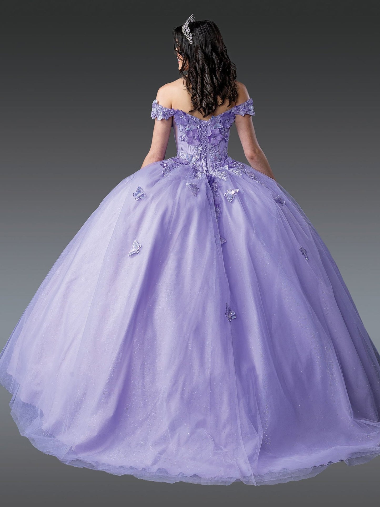 Back view of a woman wearing lilac quinceañera dress with lace-up corset, embroidered bodice, floral appliques and full skirt