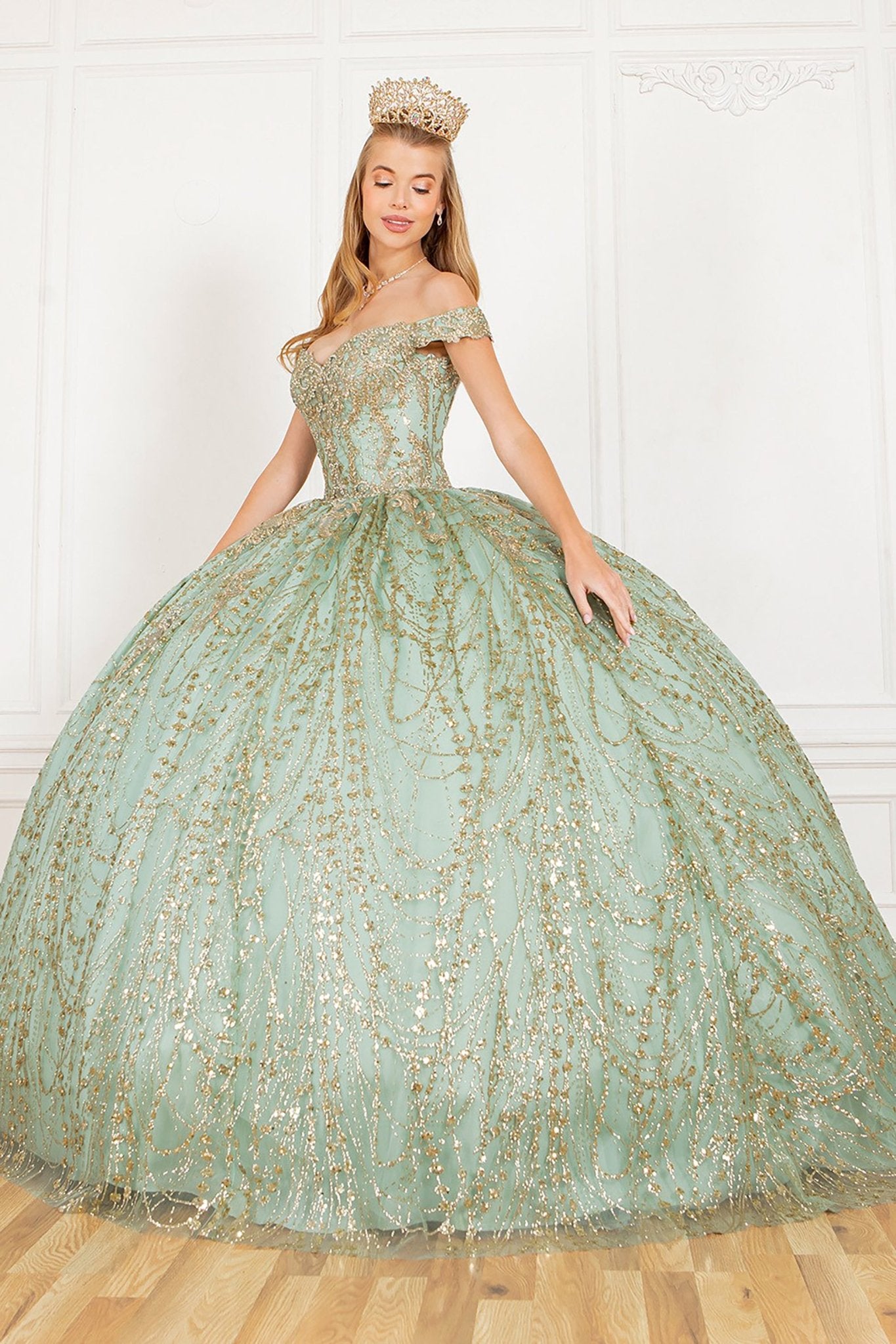 a girl wearing a sage gold ball gown with tiara