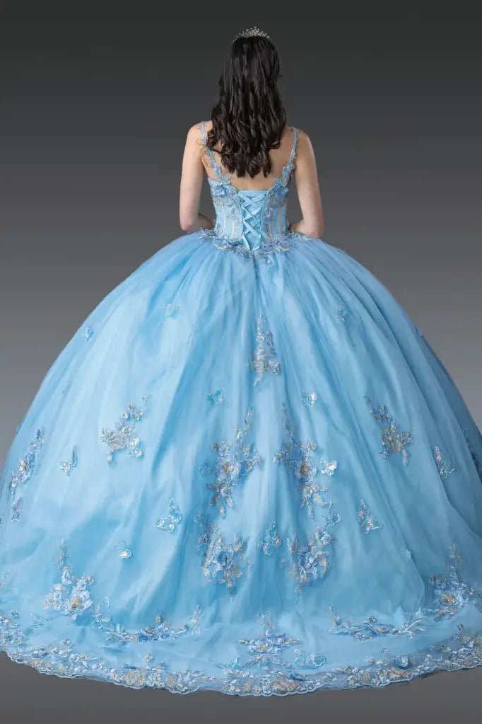 Back view of Bahama blue quinceañera ball gown showcasing lace-up corset back, sheer tulle shoulder drapes, butterfly appliqués, full ball gown skirt, and elegant silhouette photographed in studio lighting