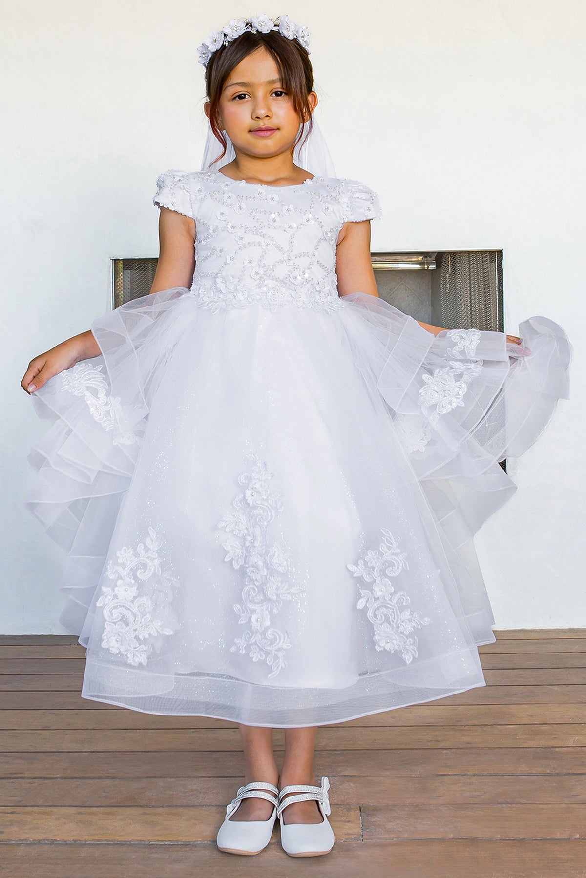Cap sleeves border the appliqued bodice on this White communion dress.