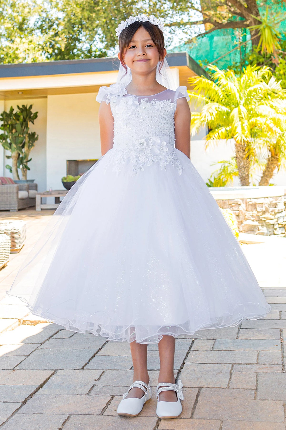 White communion dress with an illusion lace neckline and full tulle skirt.