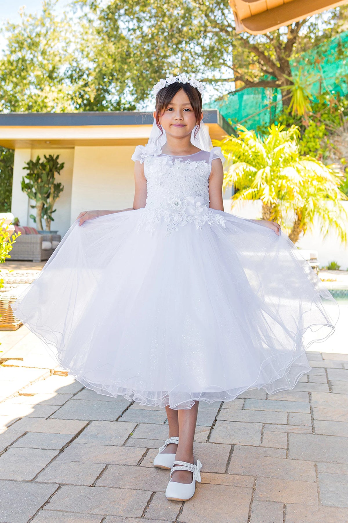 Gathered tulle forms the flowing skirt of this White communion dress.