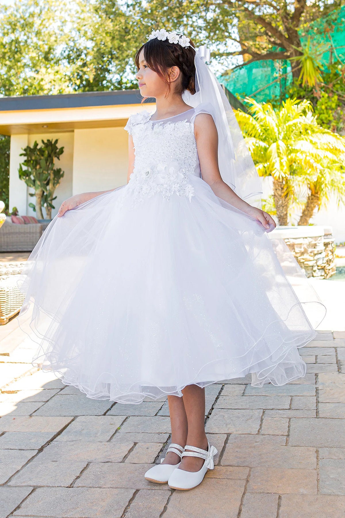 Cap sleeves and floral appliques frame the White communion dress bodice.