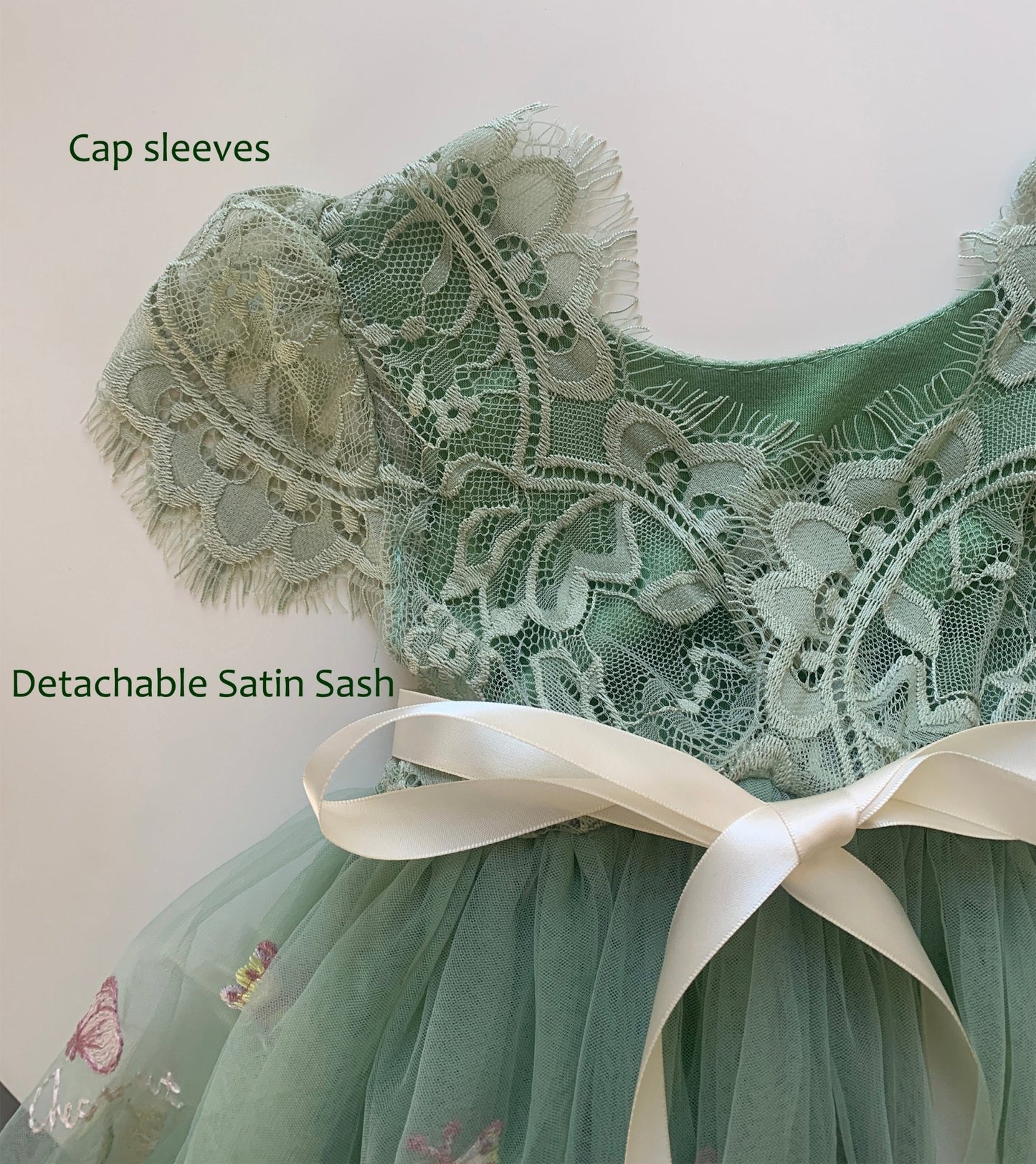 Green lace flower girl dress with cap sleeves and detachable satin sash.