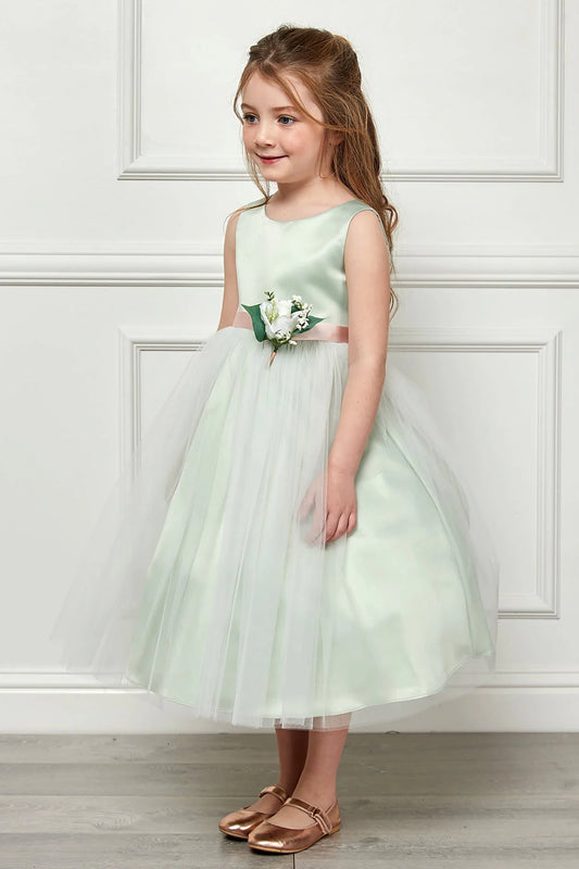 A light green flower girl dress with a floral corsage.