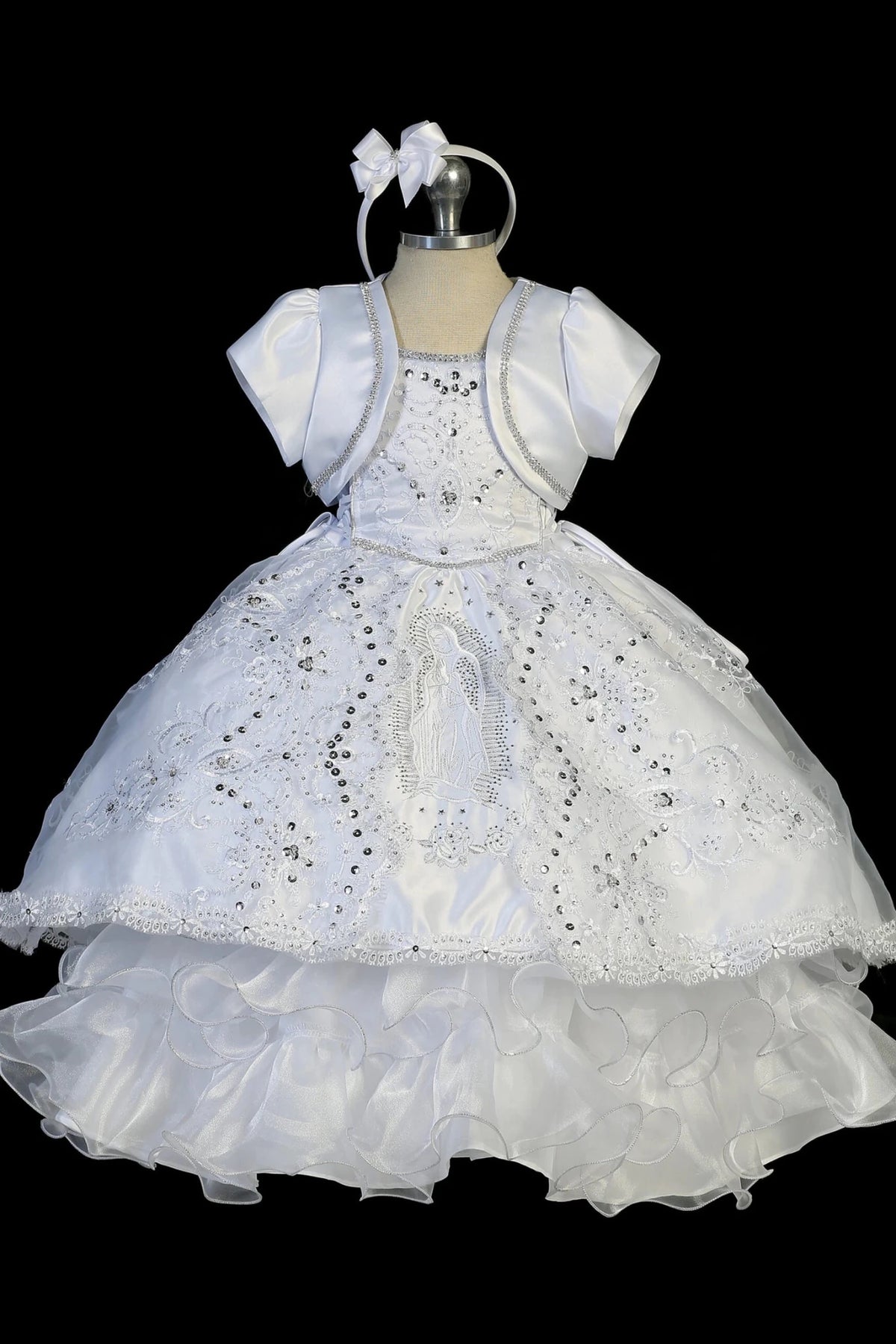 White baptism dress with double spaghetti straps and a sequined lace bodice.