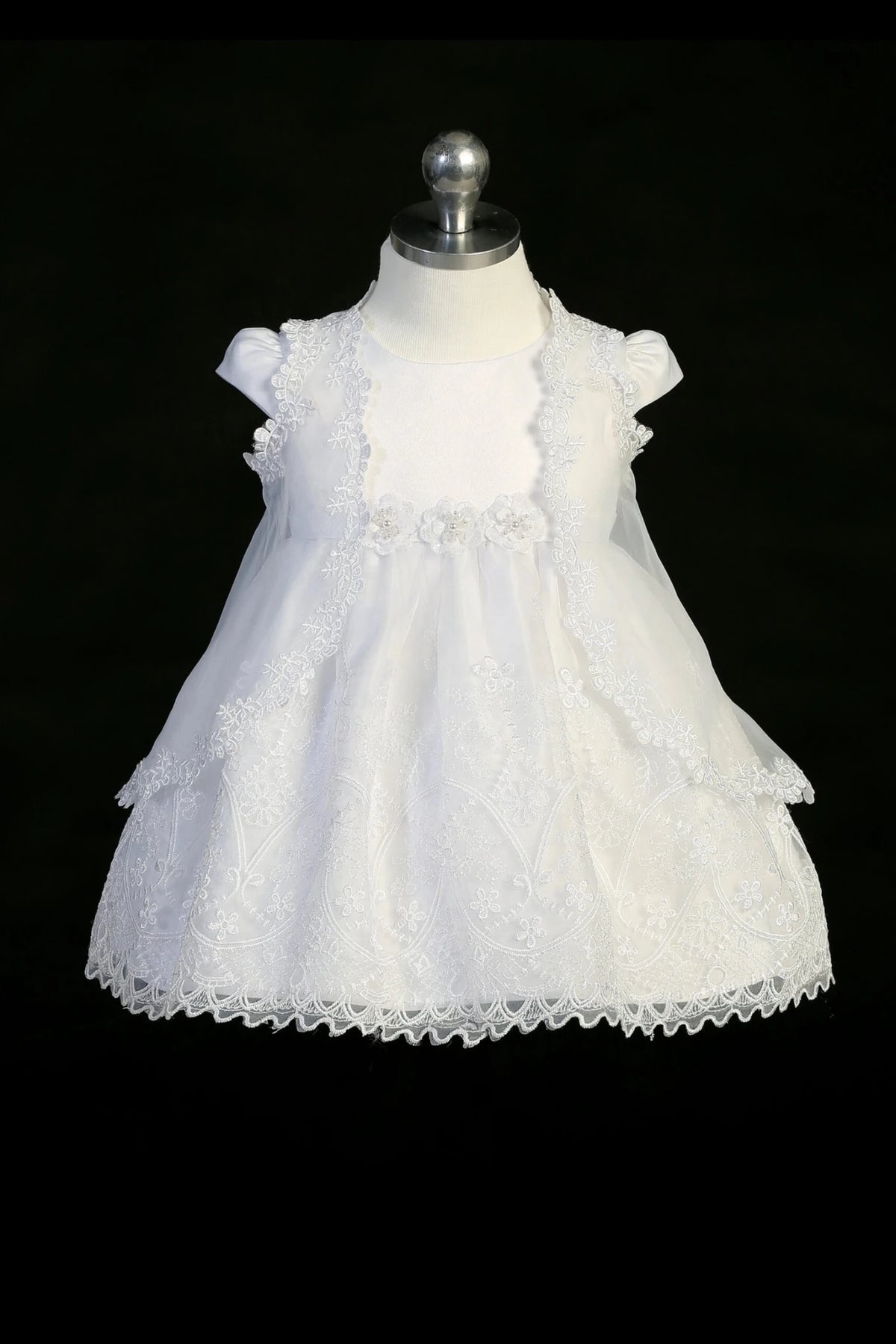 White christening dress with cap-sleeved satin bodice and a satin waist sash.