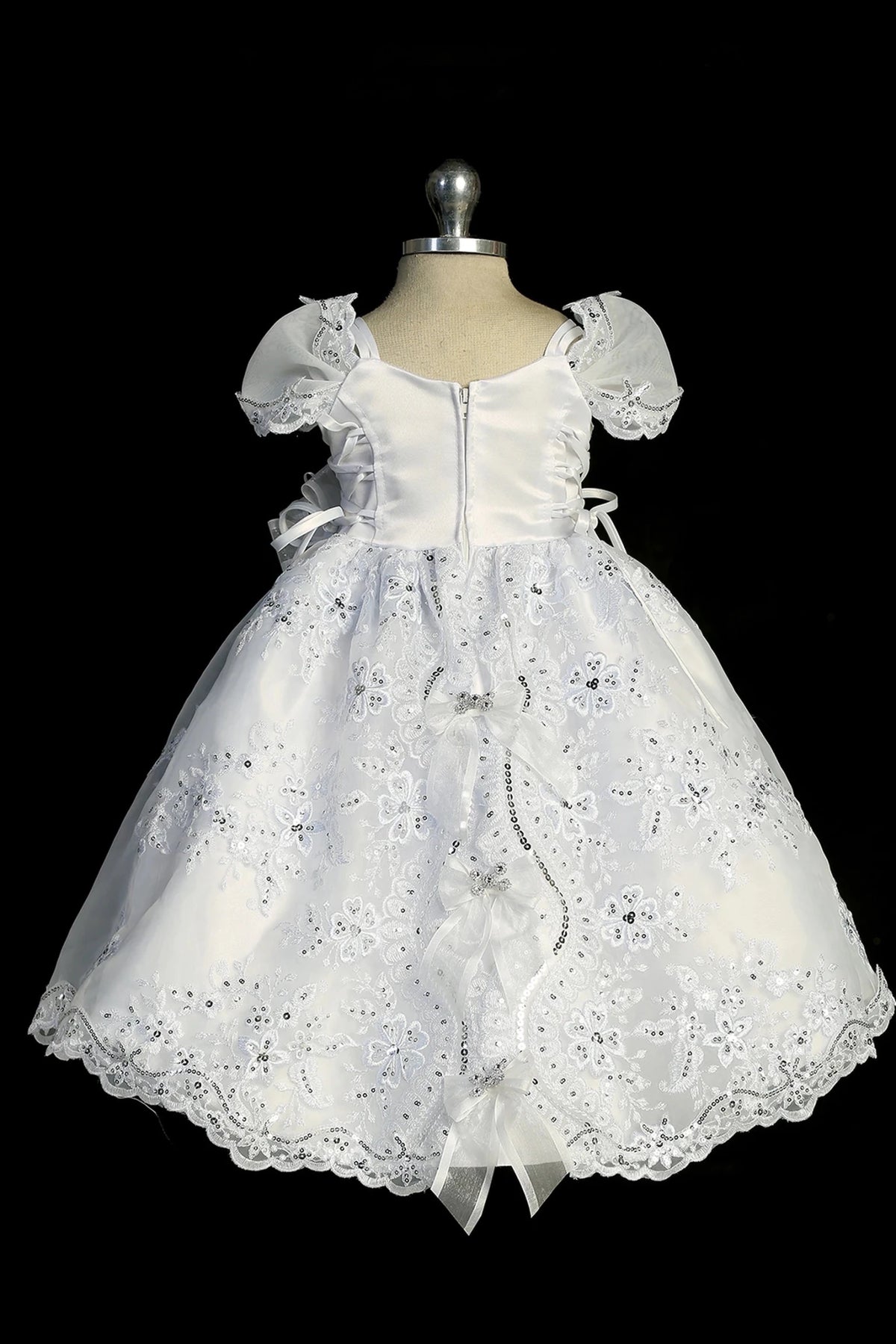 Another view of the white christening dress with short-sleeved lace bodice.