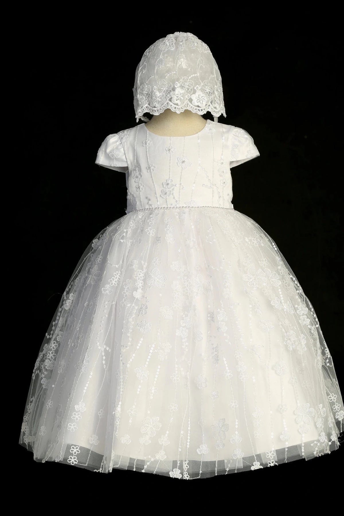 White baptism dress showing matching bonnet and lace-trimmed back.