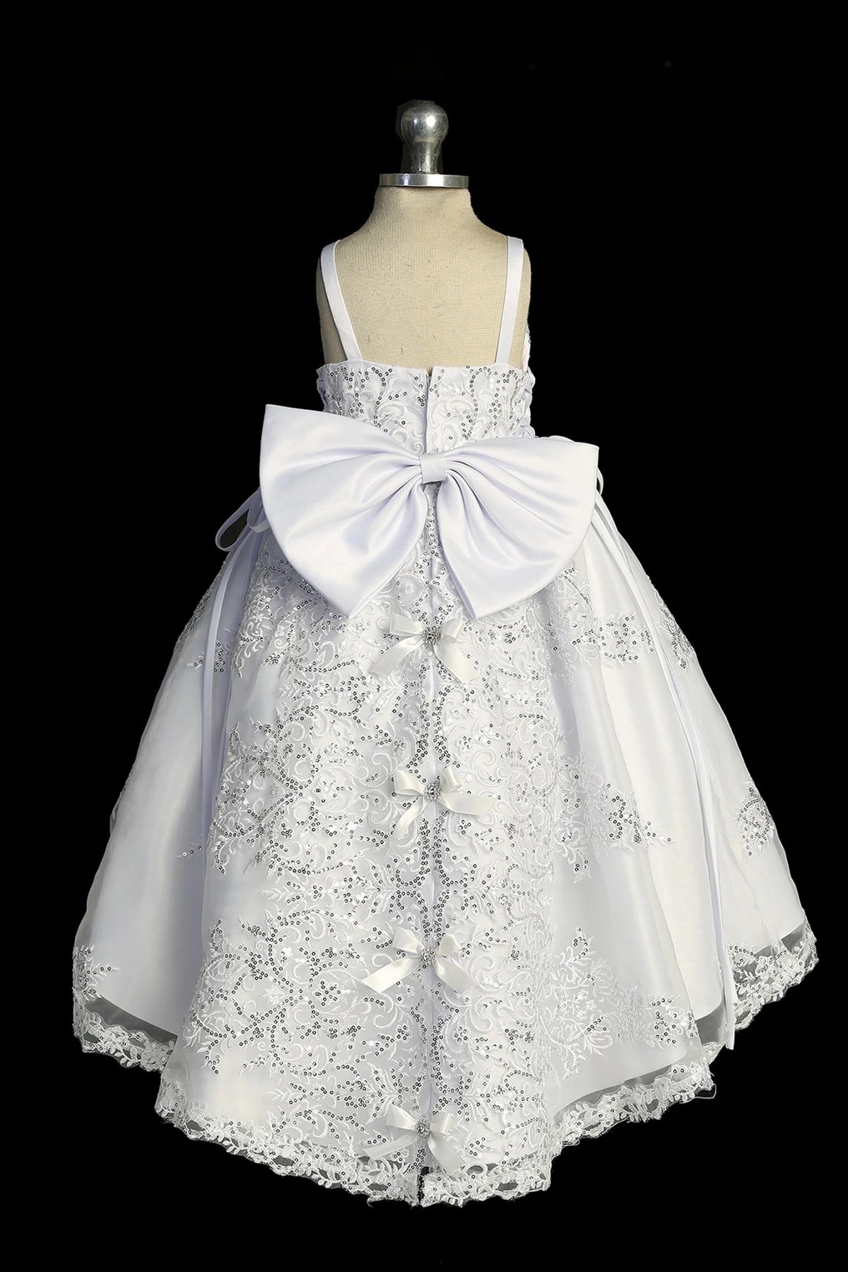 Back view of the White baptism dress showing large satin back bow and lace skirt.