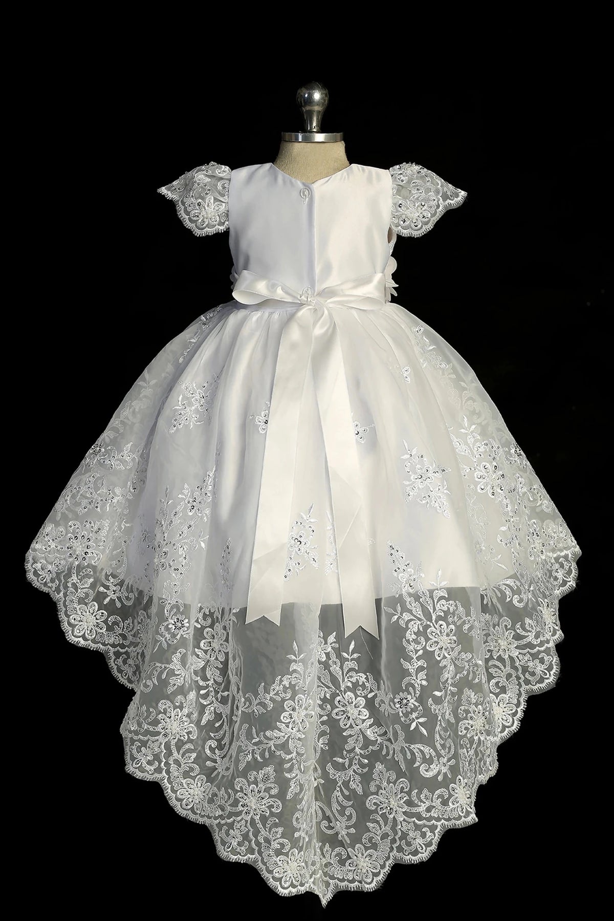 Back view of the White baptism dress showing large satin back bow and lace train.