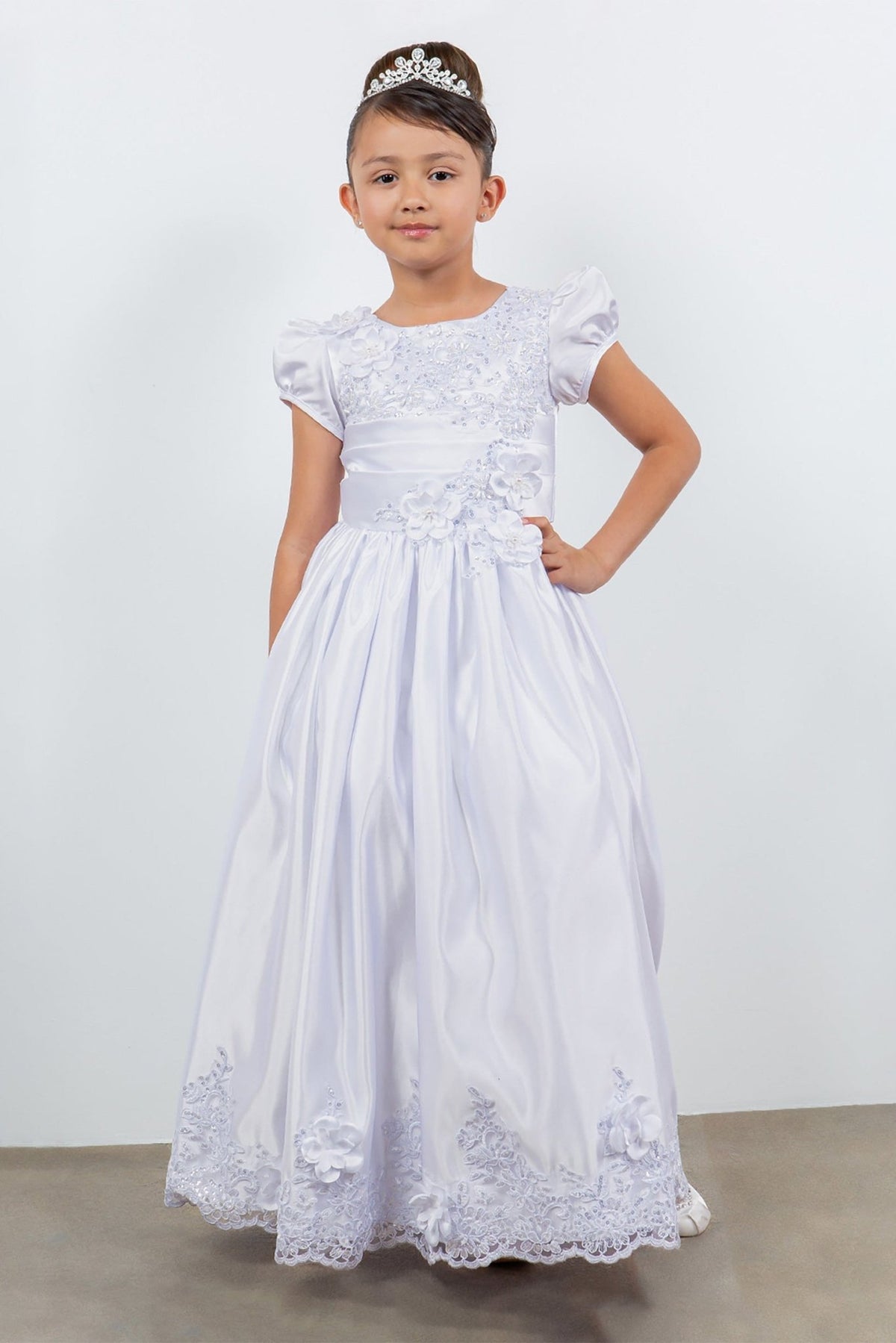 Detailed view highlights a white lace communion dress.