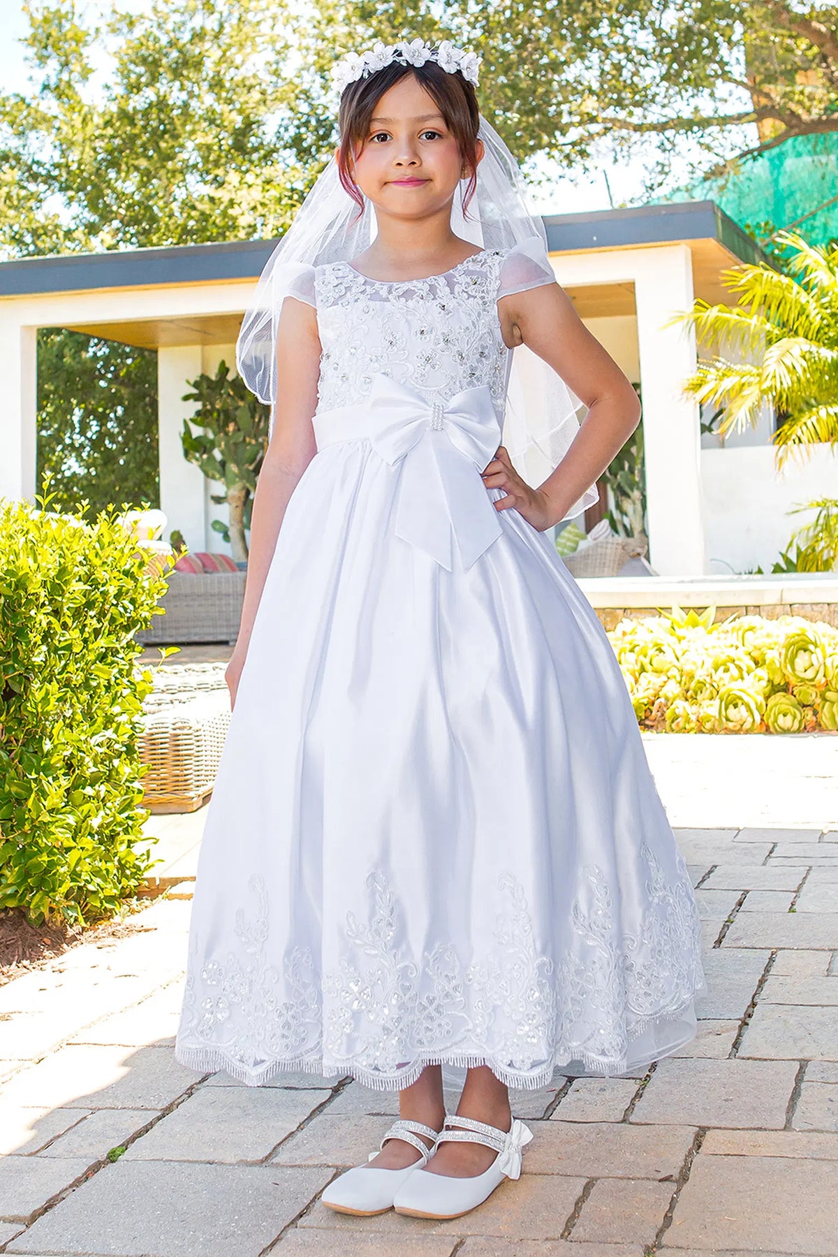 Sheer cap sleeves frame the floral bodice on this White communion dress.