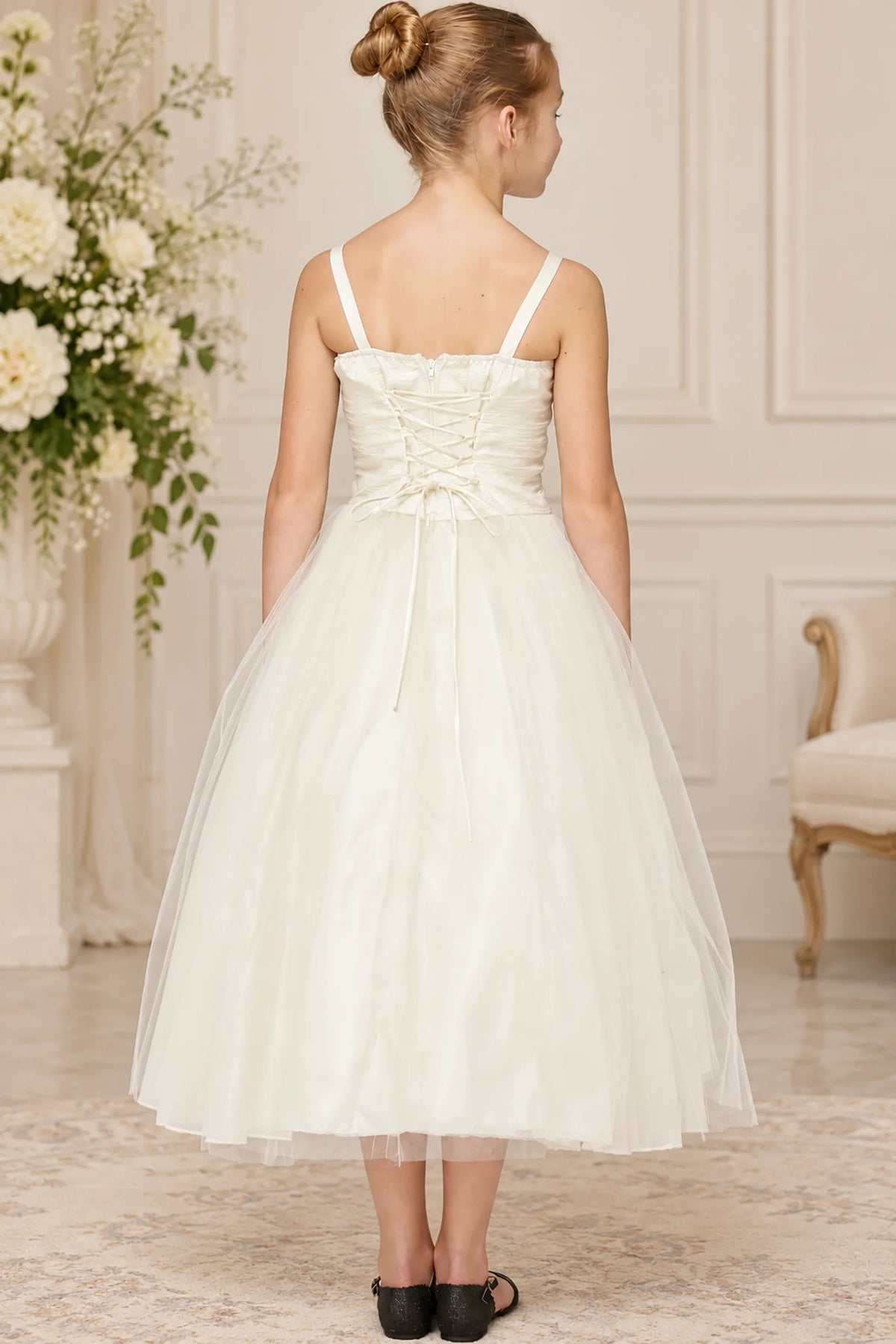 Lacing defines the back of this Ivory tulle flower girl dress.