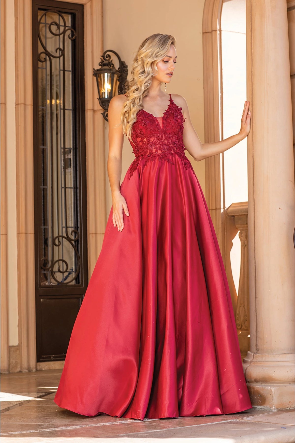 Featuring a floor-length skirt, this Burgundy prom dress is shown in full view.