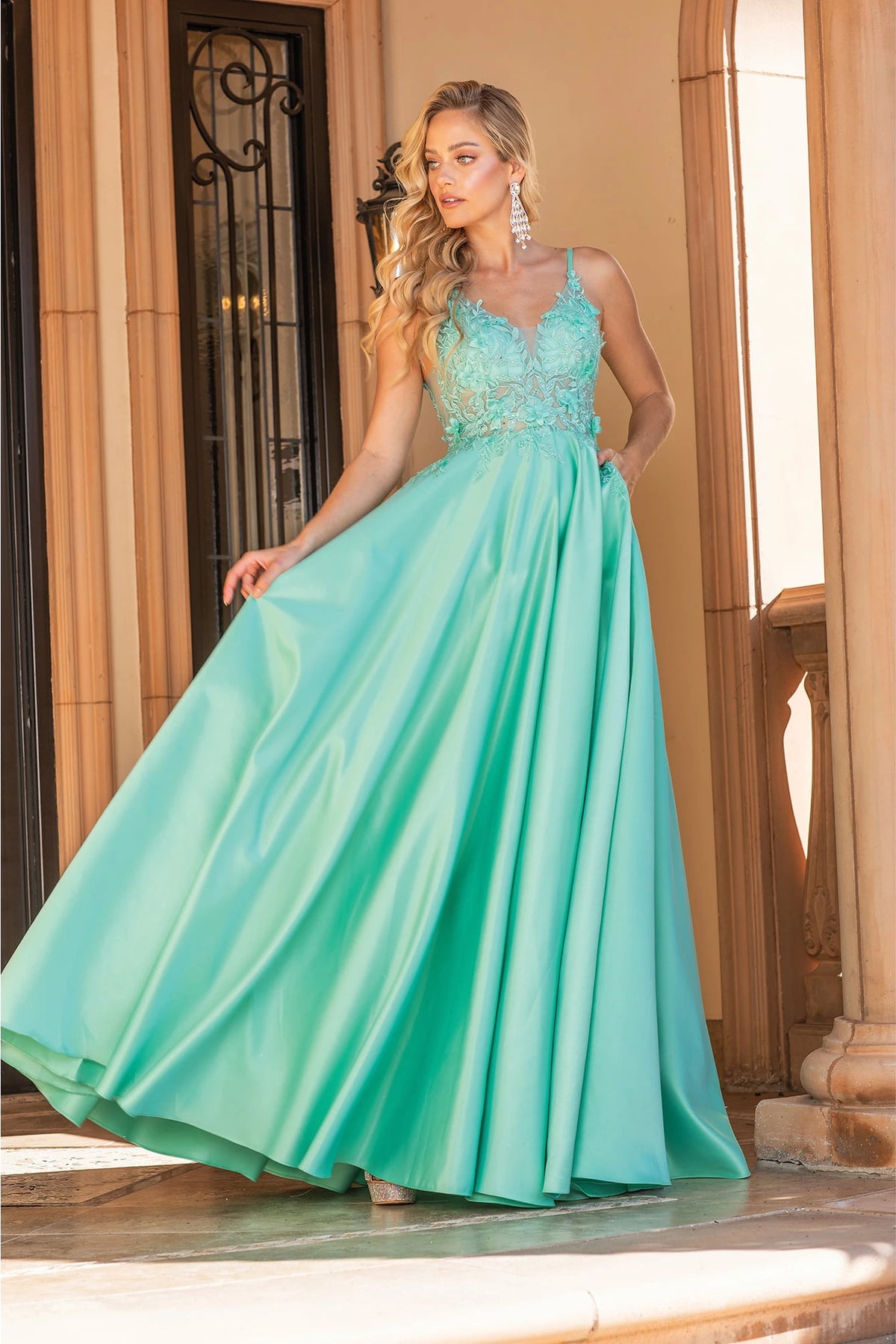 Featuring a floor-length skirt, this Mint prom dress is shown in full view.