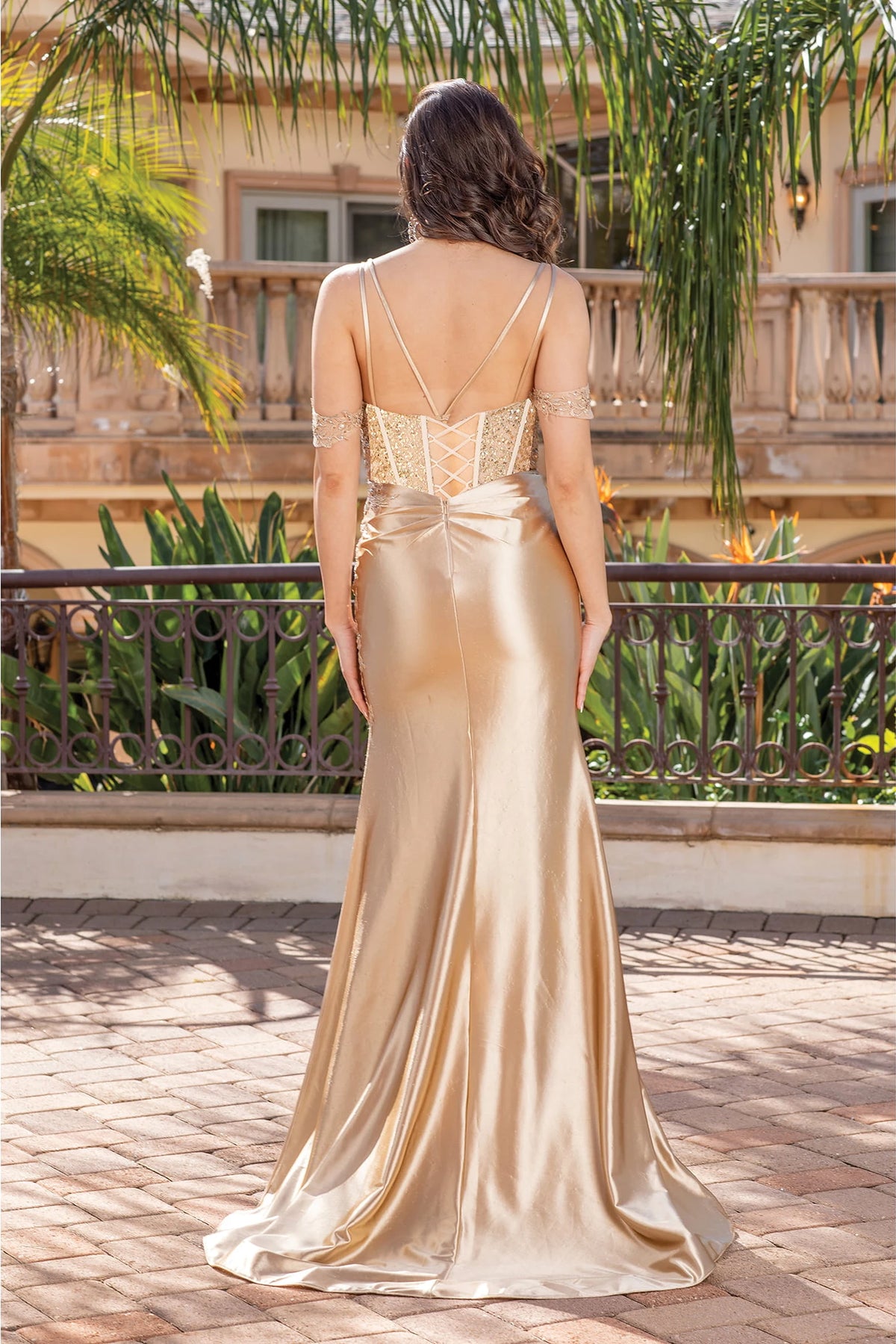 Showing its floor-length skirt, the Gold prom dress highlights the garment construction.