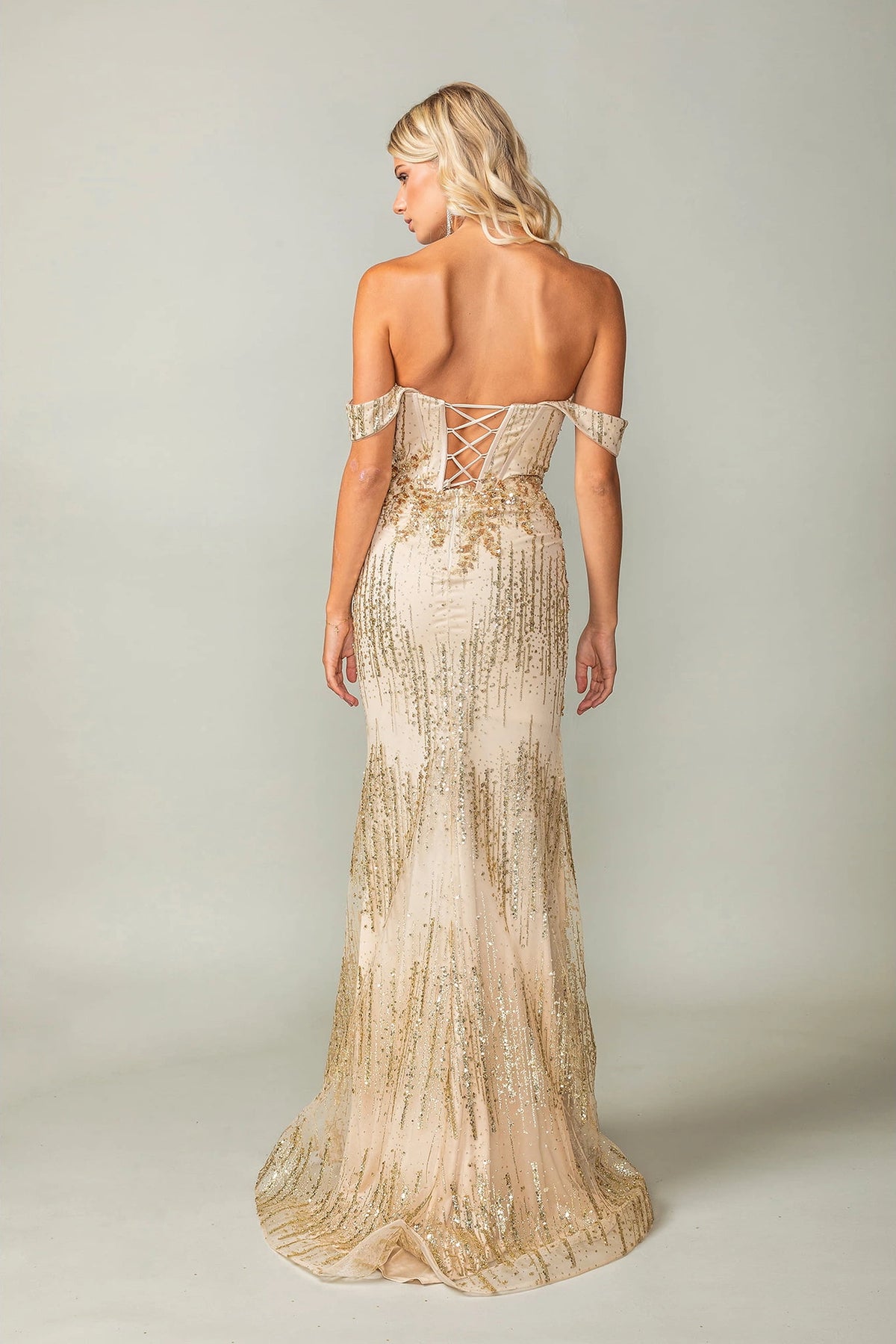 From the back, the Gold prom dress reveals its floor-length skirt.