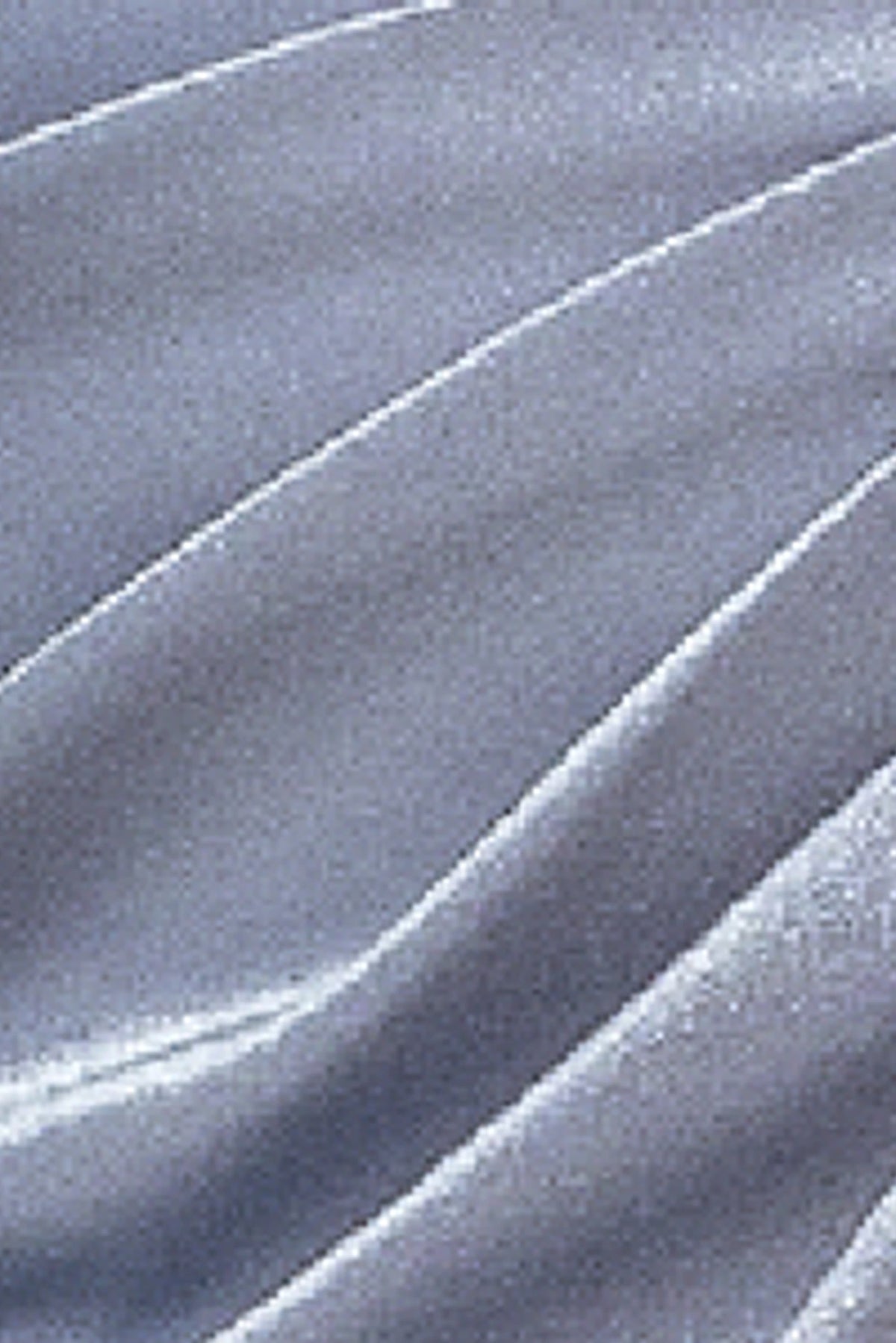 Featuring textured embellishments, this Silver prom dress is shown in detail.