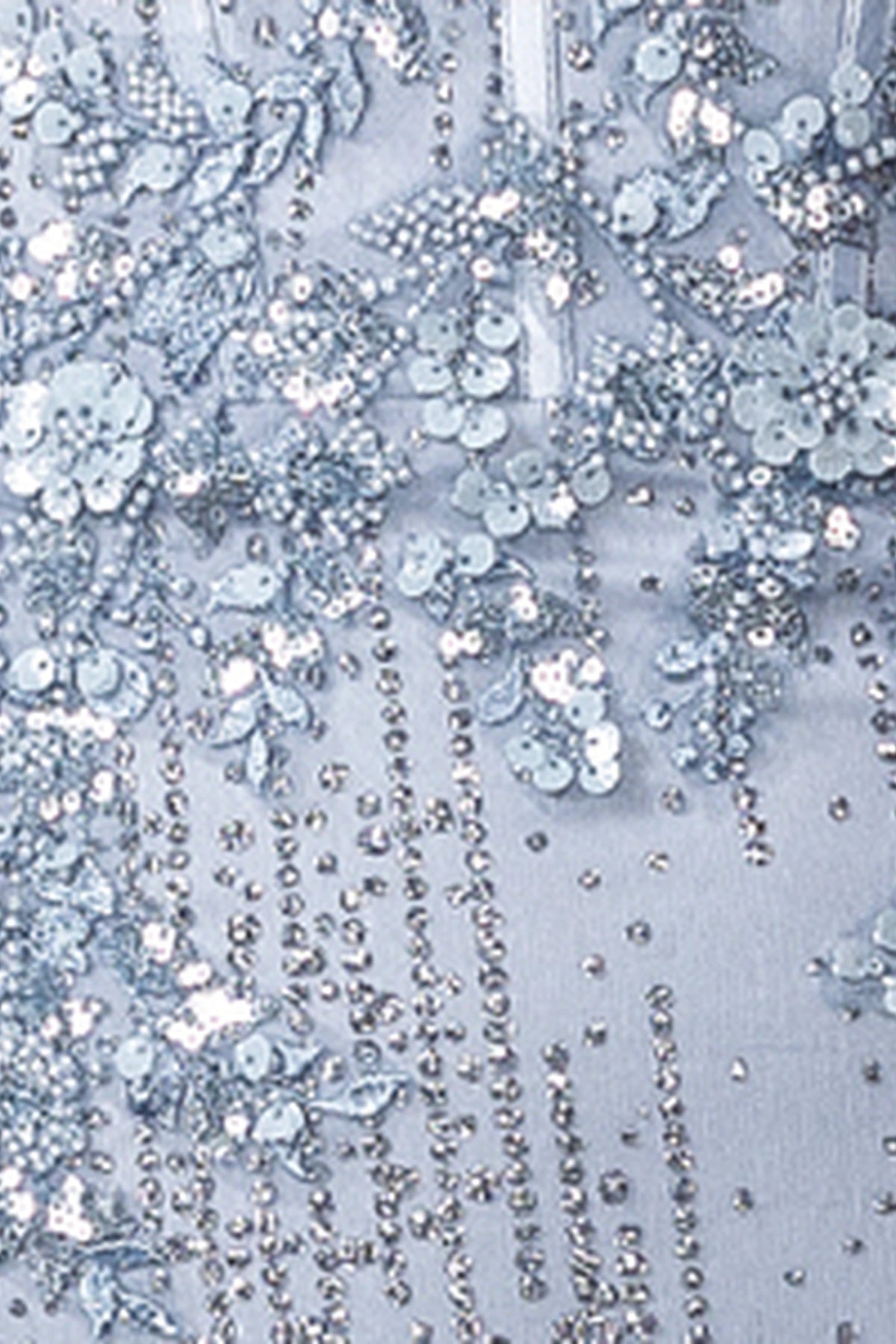 Featuring textured embellishments, this Dusty Blue prom dress is shown in detail.