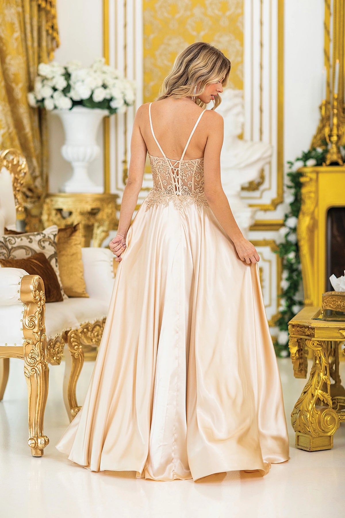 From the back, the Gold prom dress reveals its floor-length skirt.