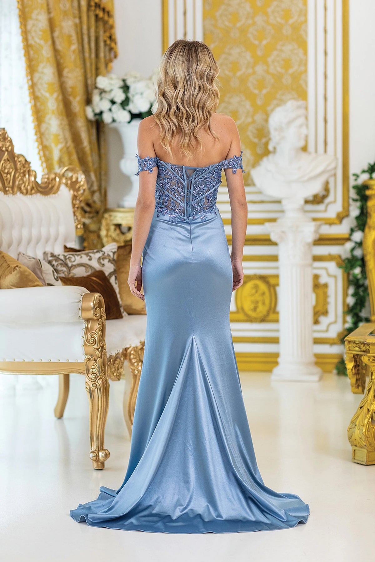 From the back, the Dusty Blue prom dress reveals its floor-length skirt.