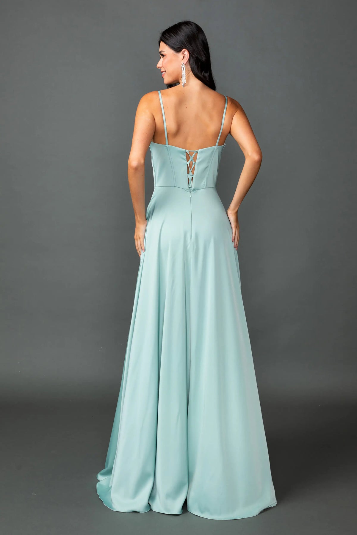 Revealing a structured bodice above its flowing satin skirt, this Sage prom dress is shown from the back.