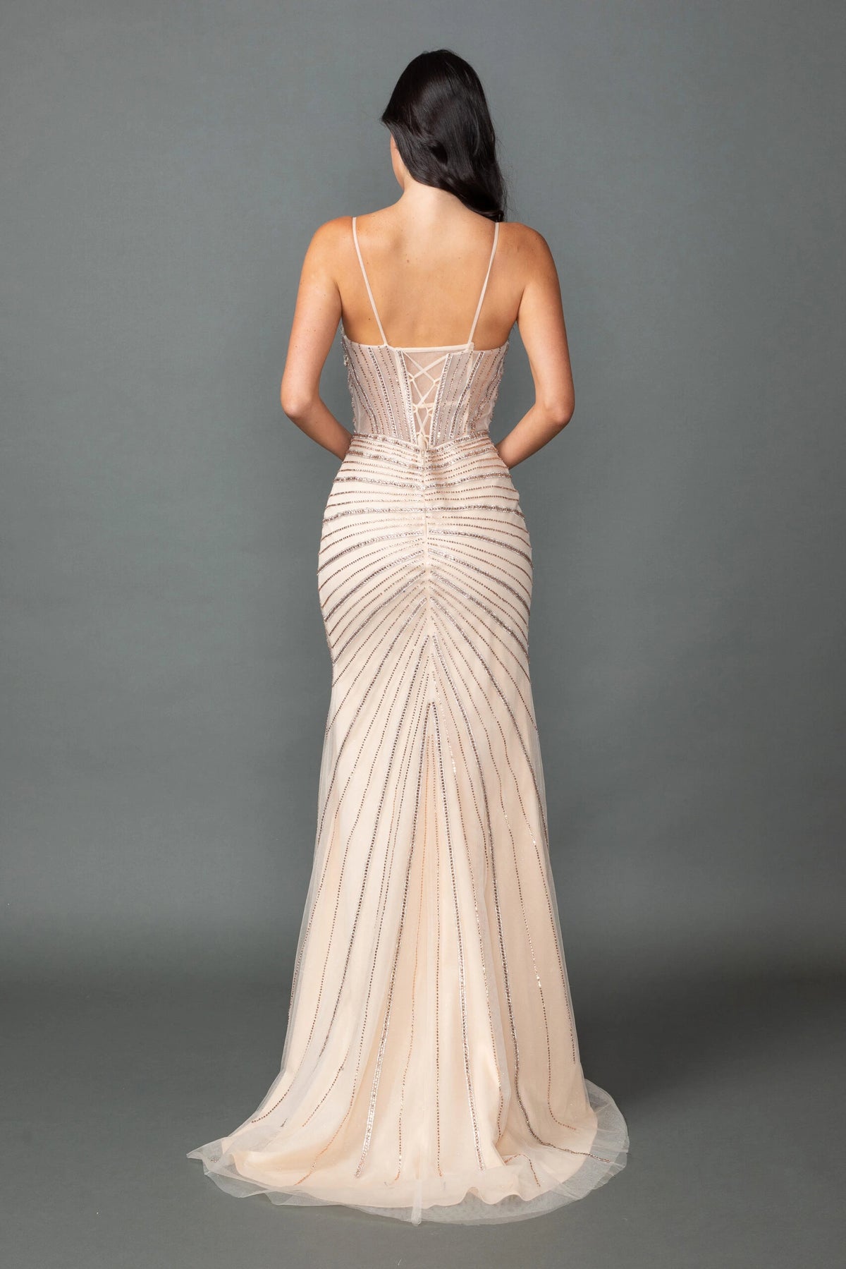From the back, the Champagne prom dress reveals its floor-length skirt.