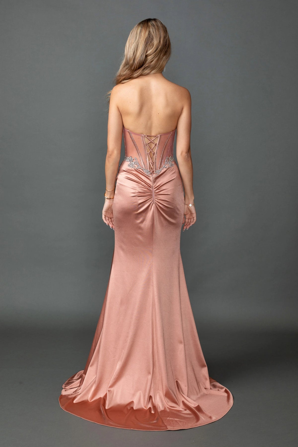 From the back, the Rose Gold prom dress reveals its floor-length skirt.