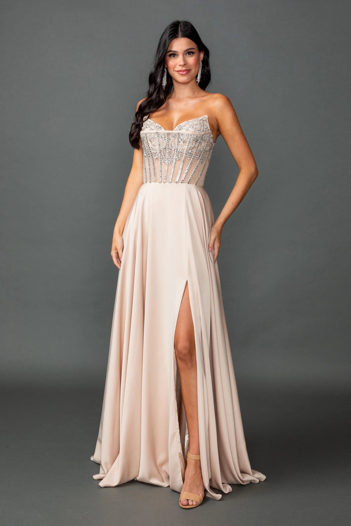Featuring a floor-length skirt, this Champagne prom dress is shown in full view.