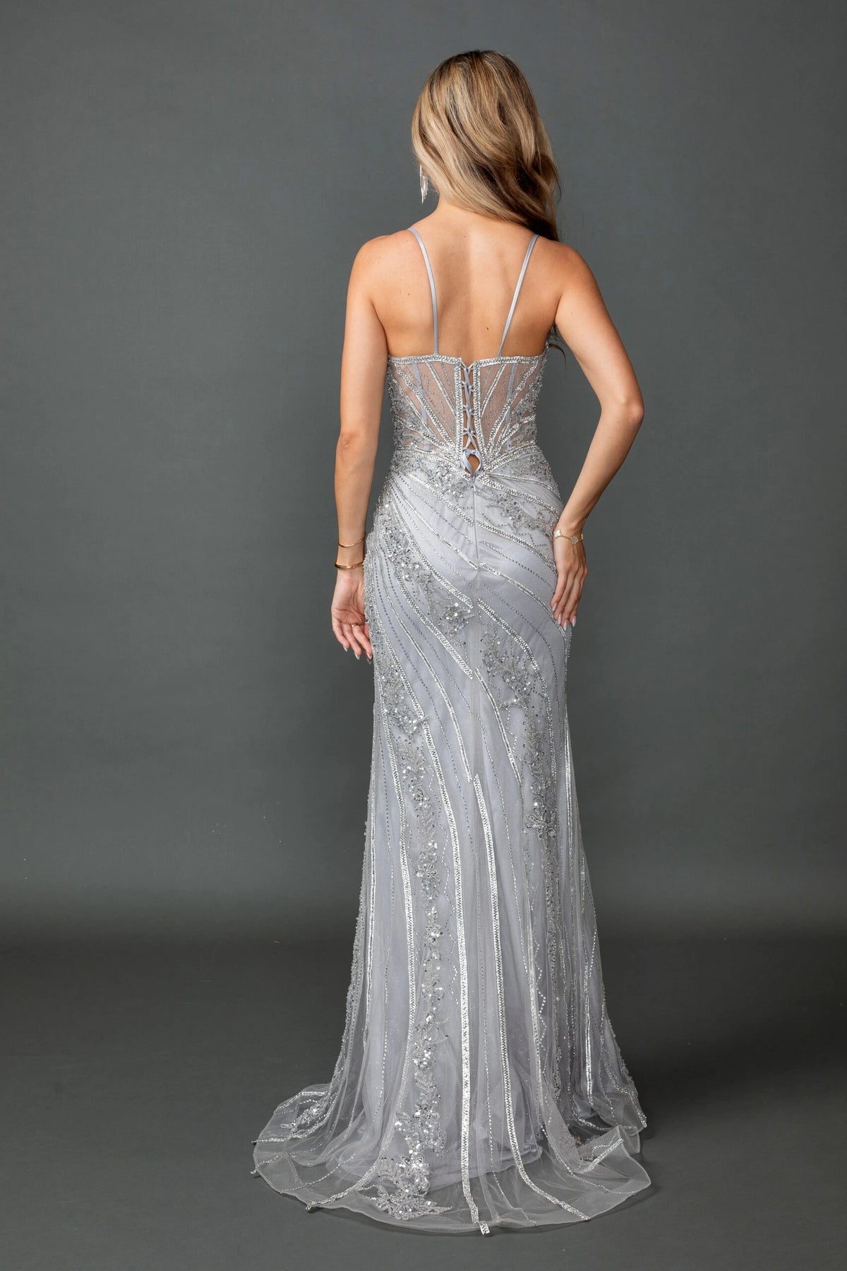 From the back, the Silver prom dress reveals its floor-length skirt.