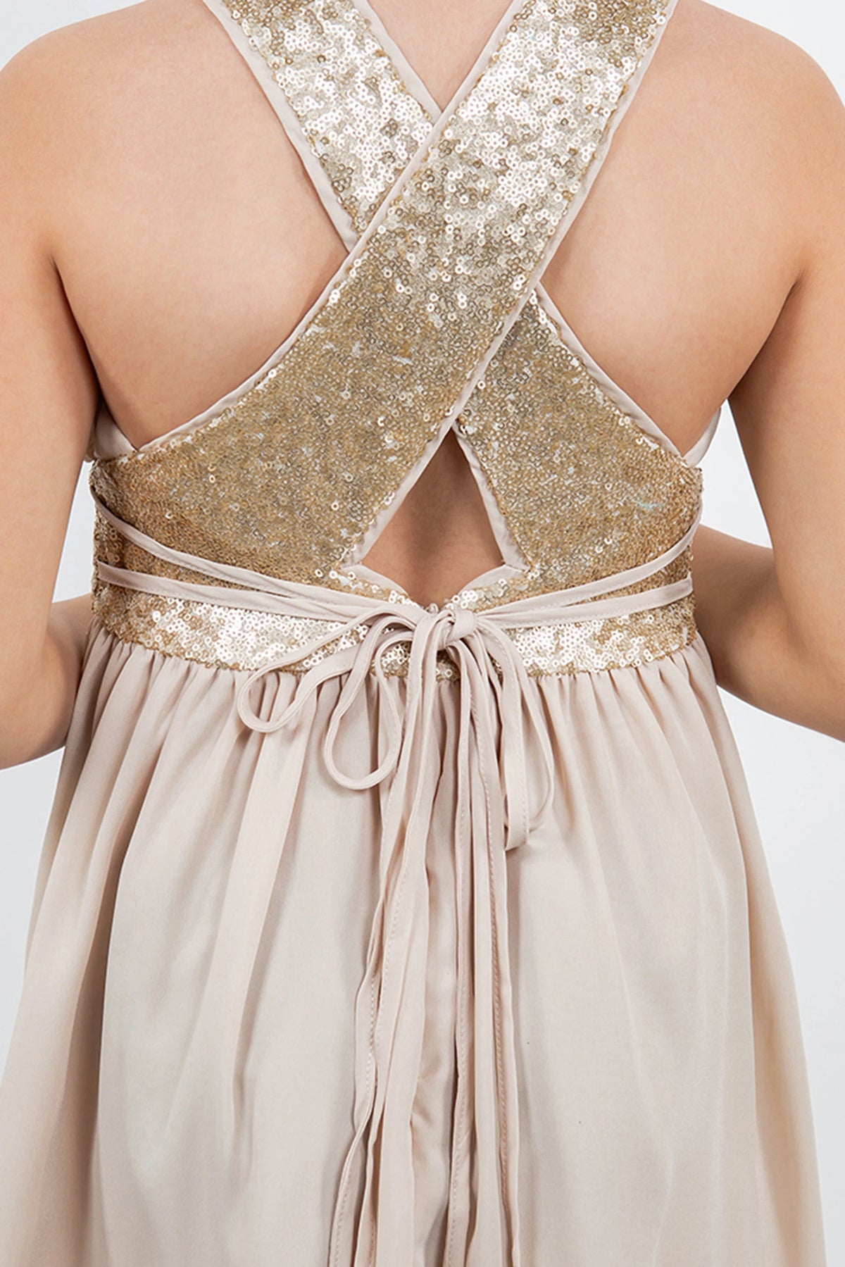Detailed by a sequin-trimmed waistband, the Champagne kids party dress reveals its construction.