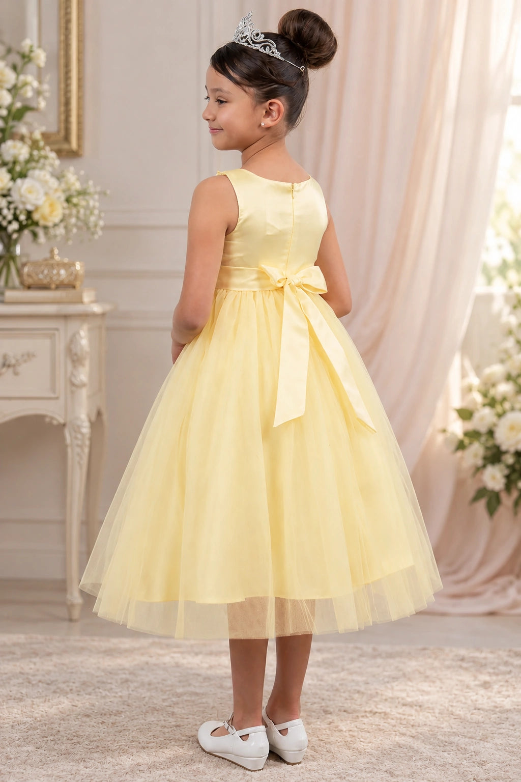 The back of this Champagne flower girl dress features a satin bodice and a tied waist bow.