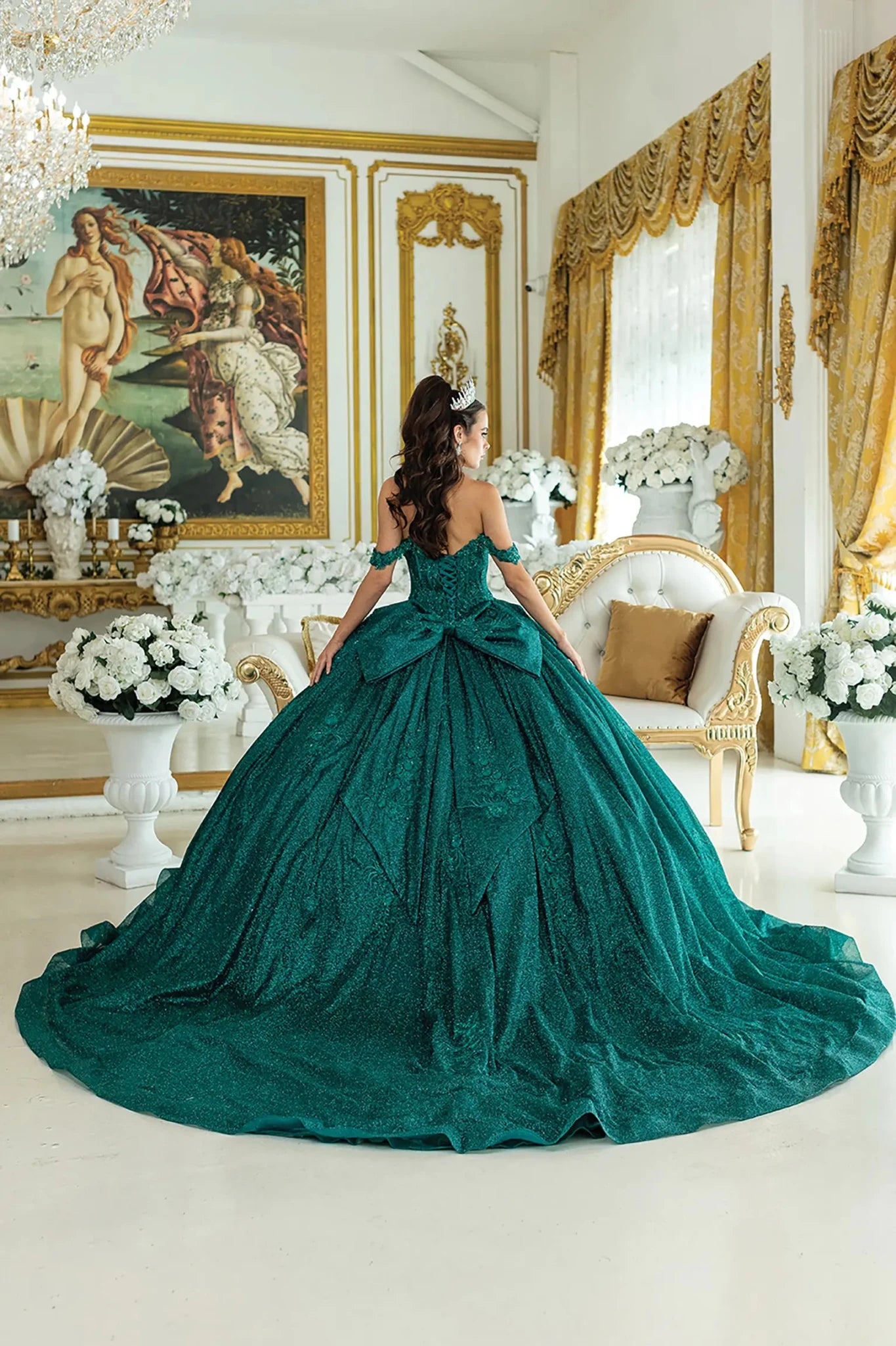 Hunter green quinceanera ball gown back view showing lace up corset back, oversized bow detail, dramatic full skirt, and sweeping train