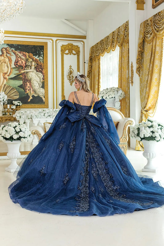 Back view of a woman wearing navy quinceañera gown, corset Back, puff sleeves, floral embroidery, glitter tulle