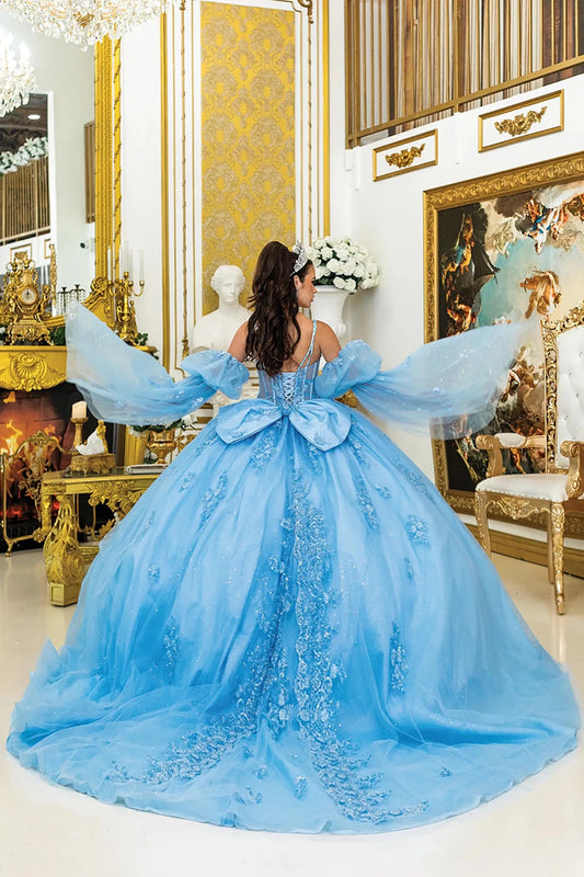 a woman wearing bahama blue quinceañera, lace-up back, detachable puff sleeves and long train with embroidery
