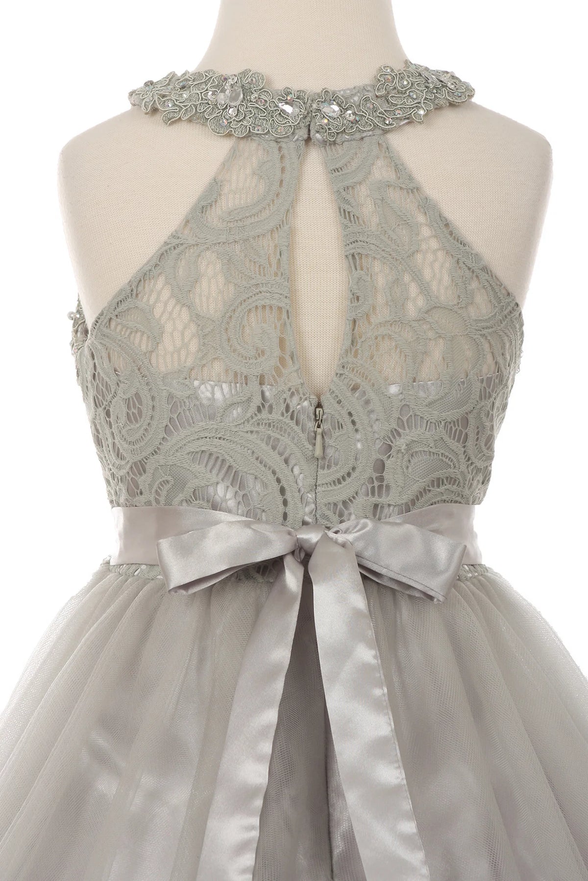 Details of the Silver kids dress show keyhole opening framed by lace.