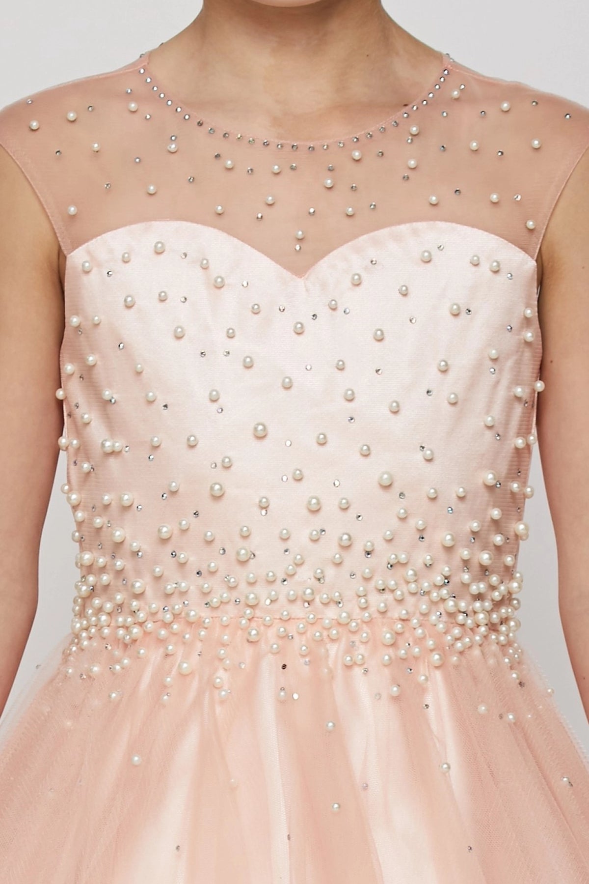 Finished details of pearl accents on the bodice distinguish the Blush kids party dress.